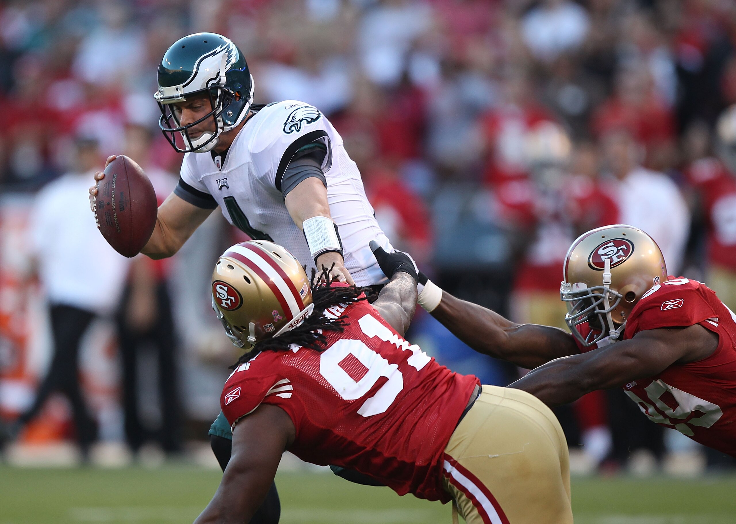 SAN FRANCISCO - OCTOBER 10:  Kevin Kolb #4 of the Philadelphia Eagles runs with the ball against Ray McDonald #91 and Manny Lawson #99 of the San Francisco 49ers during an NFL game at Candlestick Park on October 10, 2010 in San Francisco, California.  (Ph