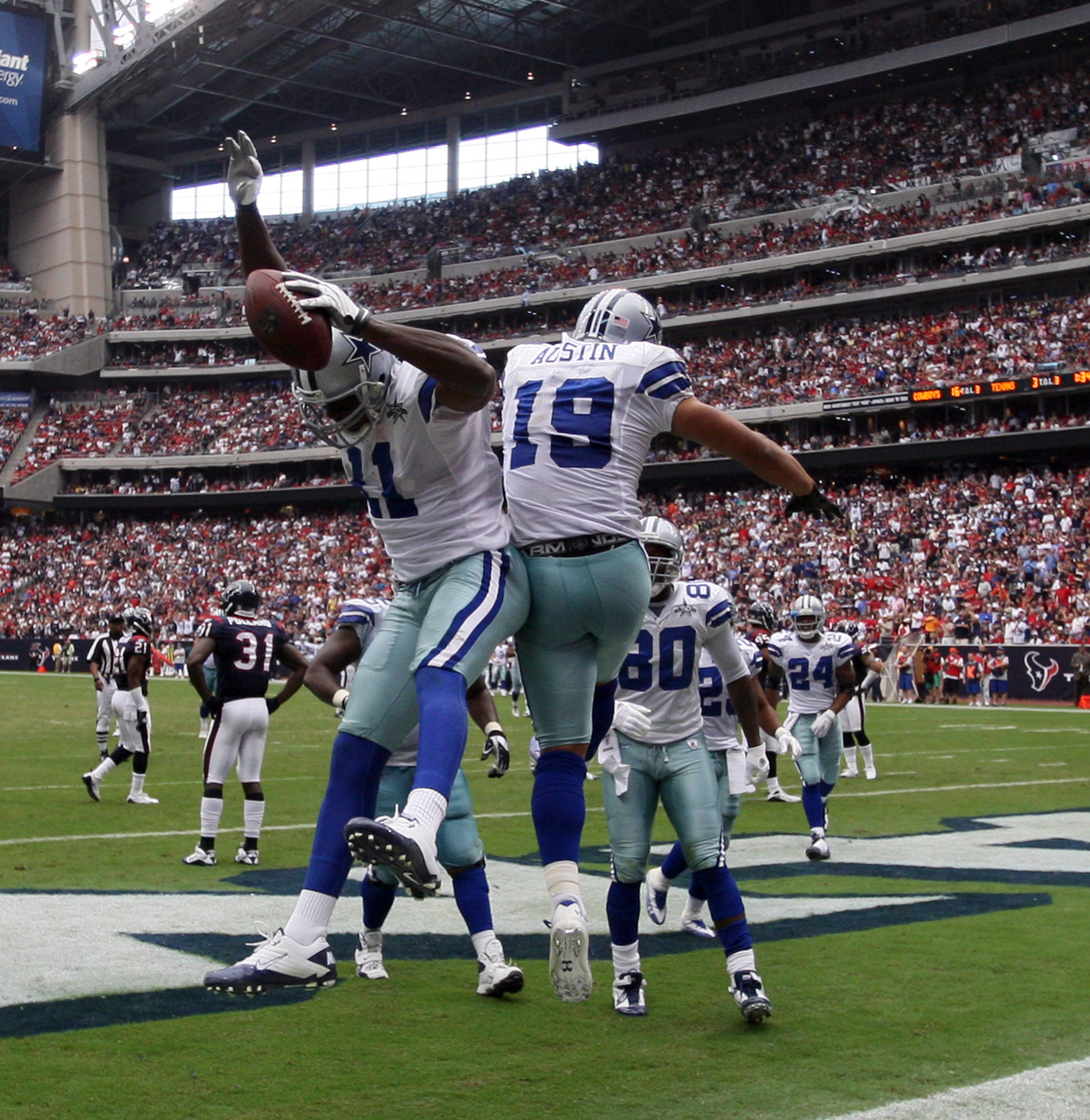HOUSTON - SEPTEMBER 26:  Wide receiver Roy Williams #11 and Miles Austin #11 celebrate after scoring on a 15 yard pass from Tony Romo in the third quarter at Reliant Stadium on September 26, 2010 in Houston, Texas.  (Photo by Bob Levey/Getty Images)