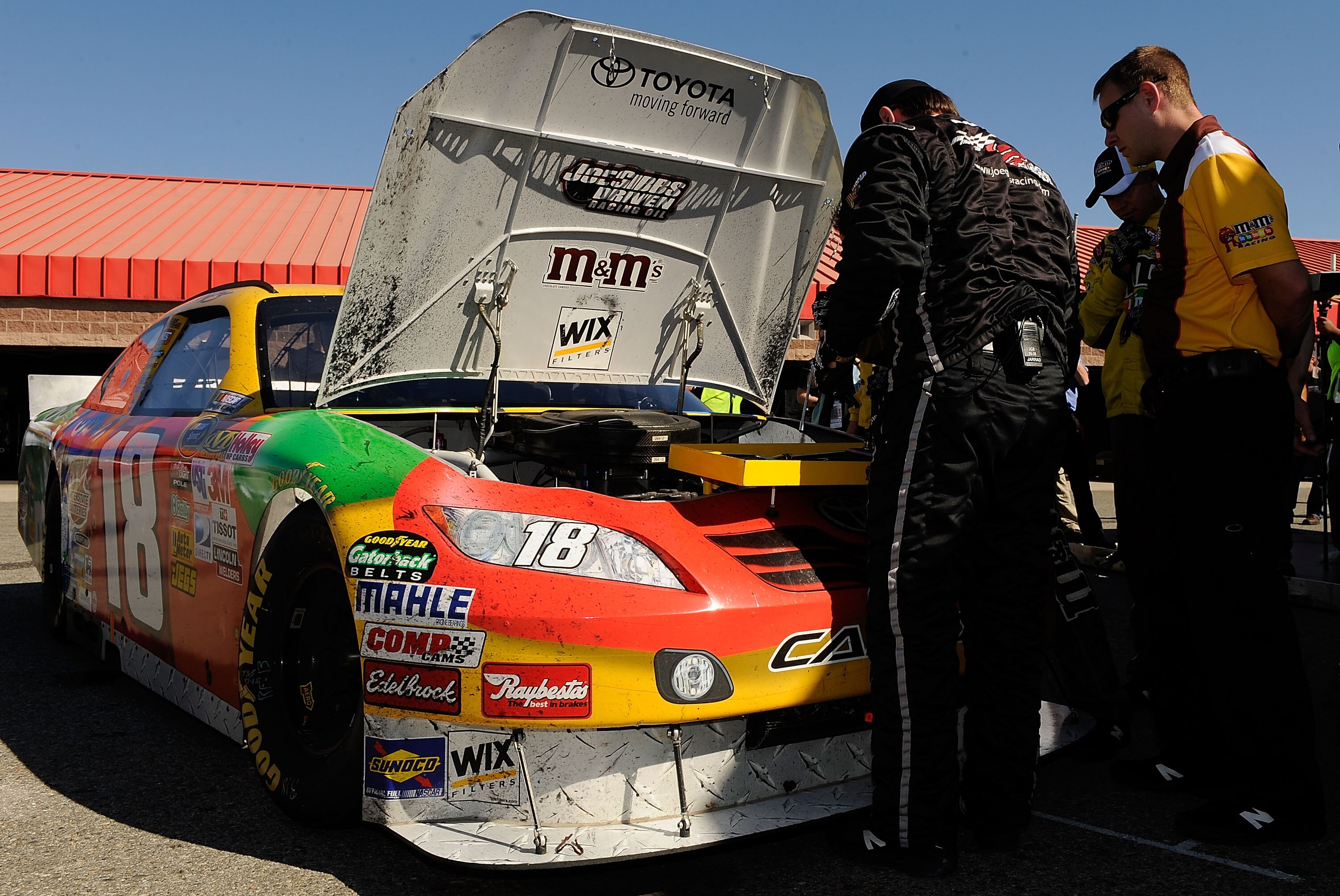 FONTANA, CA - OCTOBER 10:  Crew members for Kyle Busch, driver of the #18 M&M'sToyota, work on the car after blowing a motor during the NASCAR Sprint Cup Series Pepsi Max 400 on October 10, 2010 in Fontana, California.  (Photo by Rusty Jarrett/Getty Image