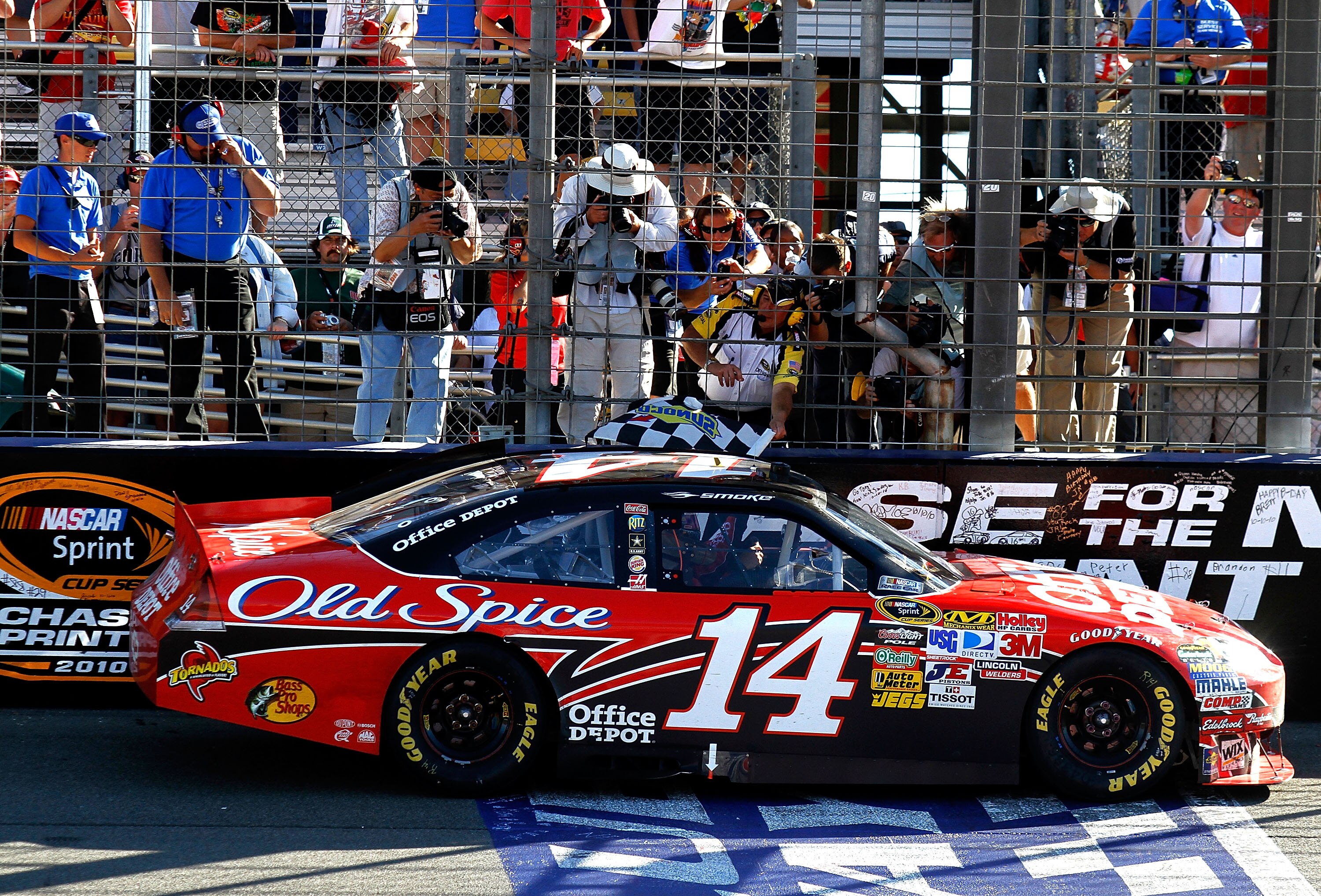 FONTANA, CA - OCTOBER 10:  Tony Stewart, driver of the #14 Office Depot Chevrolet, is handed the checkered flag after winning the NASCAR Sprint Cup Series Pepsi Max 400 on October 10, 2010 in Fontana, California.  (Photo by Jason Smith/Getty Images for NA