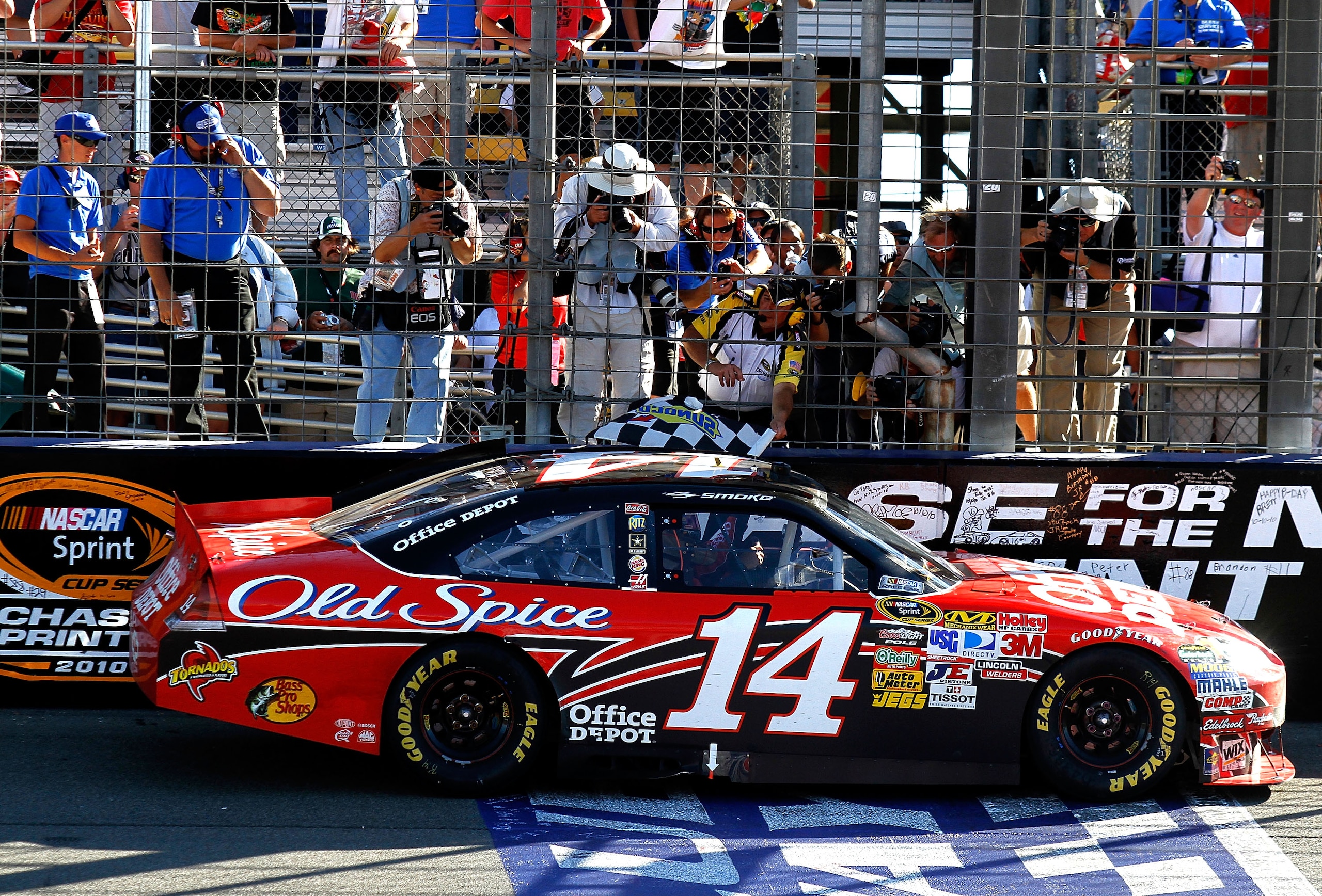 FONTANA, CA - OCTOBER 10:  Tony Stewart, driver of the #14 Office Depot Chevrolet, is handed the checkered flag after winning the NASCAR Sprint Cup Series Pepsi Max 400 on October 10, 2010 in Fontana, California.  (Photo by Jason Smith/Getty Images for NA