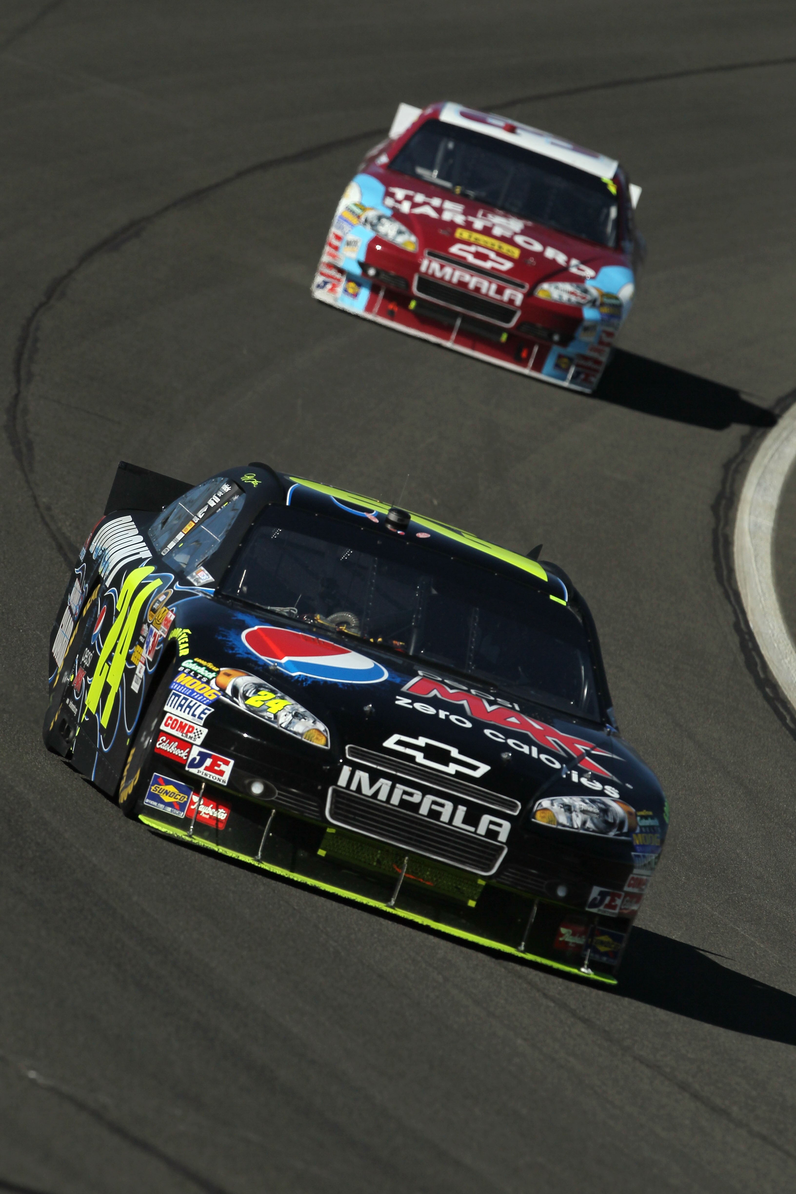FONTANA, CA - OCTOBER 10:  Jeff Gordon, driver of the #24 DuPont Chevrolet, leads Clint Bowyer, driver of the #33 The Hartford Chevrolet, during the NASCAR Sprint Cup Series Pepsi Max 400 on October 10, 2010 in Fontana, California.  (Photo by Jeff Gross/G