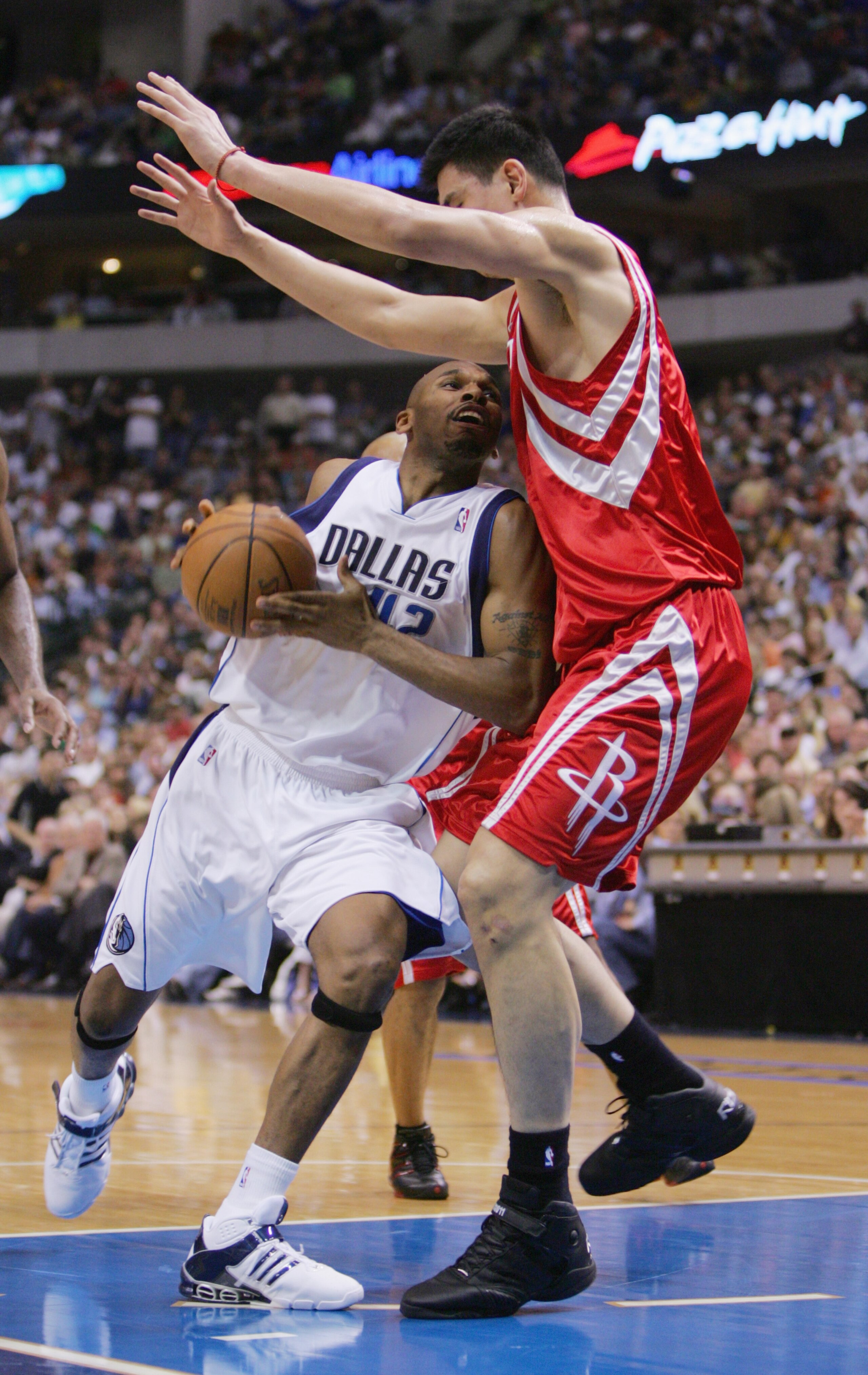 DALLAS - MAY 7: Yao Ming #11 of the Houston Rockets blocks the path of Jerry Stackhouse #42 of the Dallas Mavericks in Game seven of the Western Conference Quarterfinals during the 2005 NBA Playoffs at the American Airlines Center on May 7, 2005 in Dalla DALLAS - MAY 7: Yao Ming #11 of the Houston Rockets blocks the path of Jerry Stackhouse #42 of the Dallas Mavericks in Game seven of the Western Conference Quarterfinals during the 2005 NBA Playoffs at the American Airlines Center on May 7, 2005 in Dalla