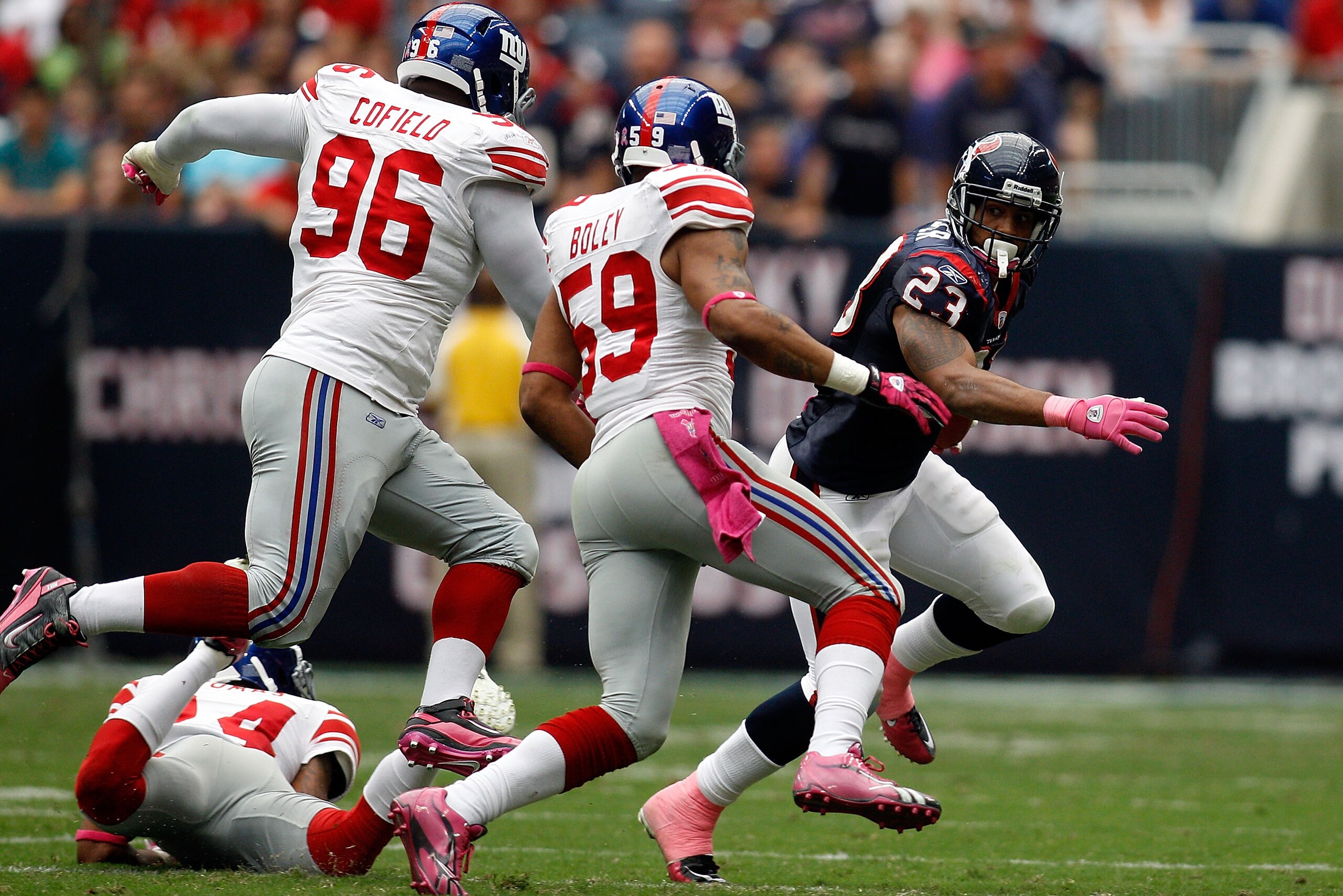 HOUSTON - OCTOBER 10:  Arian Foster #23 of the Houston Texans is chased by the New York Giants defense at Reliant Stadium on October 10, 2010 in Houston, Texas.  The Giants defeated the Texans 34-10.  (Photo by Chris Graythen/Getty Images)