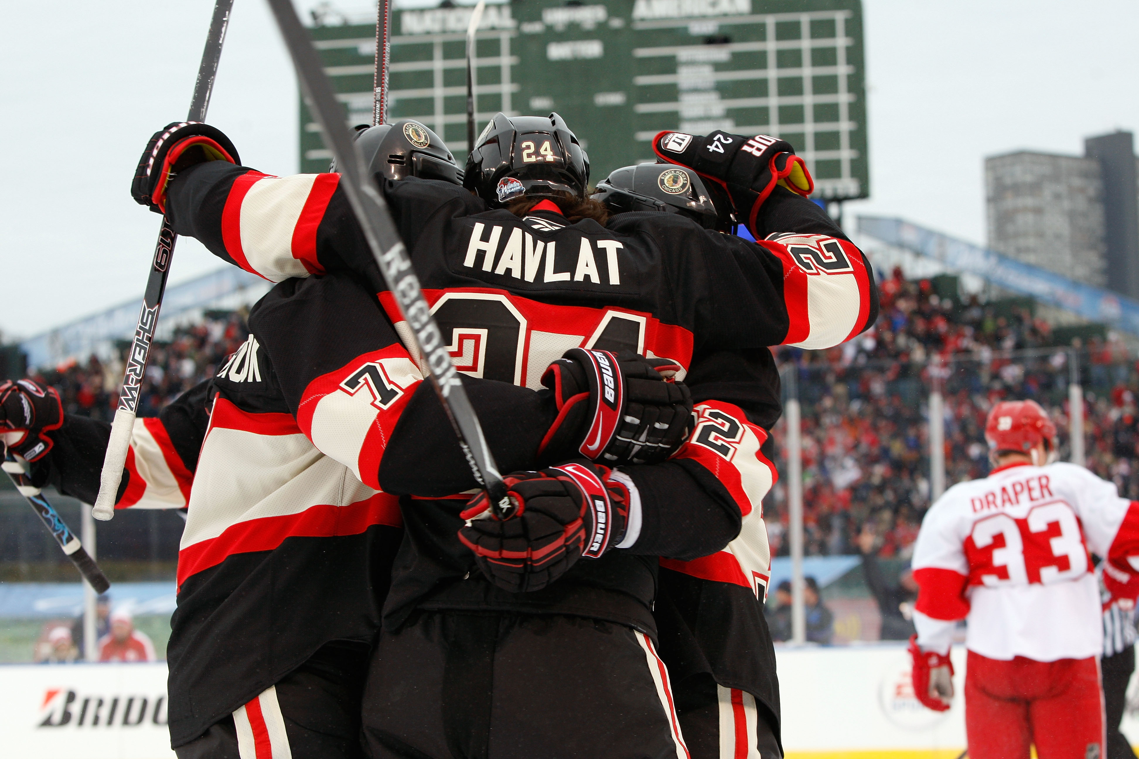 CHICAGO - JANUARY 01: (L-R) Brent Seabrook #7, Martin Havlat #24 and Kris Versteeg #32 of the Chicago Blackhawks celebrate after Versteeg scored a goal in the first period against the Detroit Red Wings during the NHL Winter Classic at Wrigley Field on Ja CHICAGO - JANUARY 01: (L-R) Brent Seabrook #7, Martin Havlat #24 and Kris Versteeg #32 of the Chicago Blackhawks celebrate after Versteeg scored a goal in the first period against the Detroit Red Wings during the NHL Winter Classic at Wrigley Field on Ja