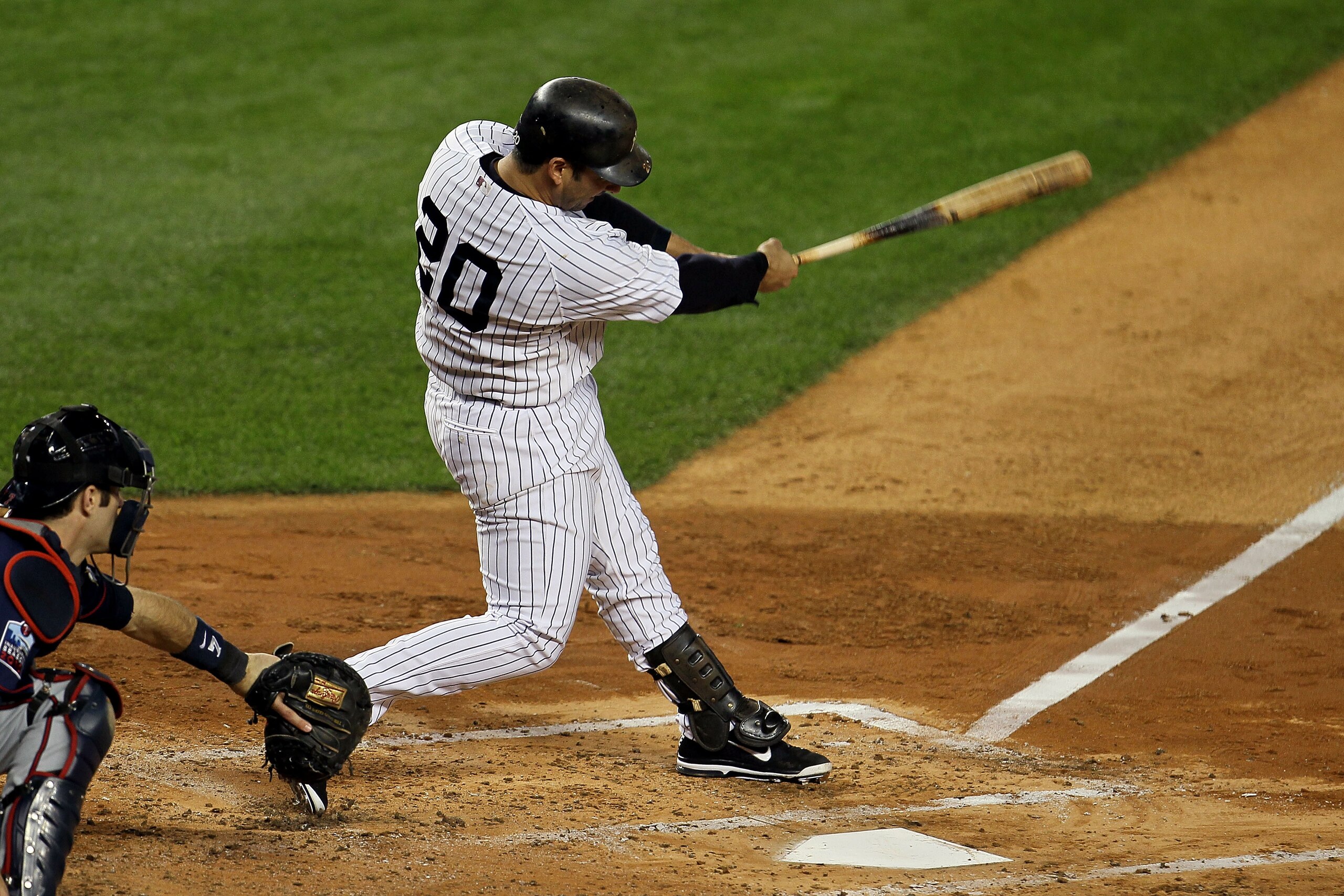 NEW YORK - OCTOBER 09:  Jorge Posada #20 of the New York Yankees hits a RBI single in the bottom of the second inning against the Minnesota Twins during Game Three of the ALDS part of the 2010 MLB Playoffs at Yankee Stadium on October 9, 2010 in the Bronx