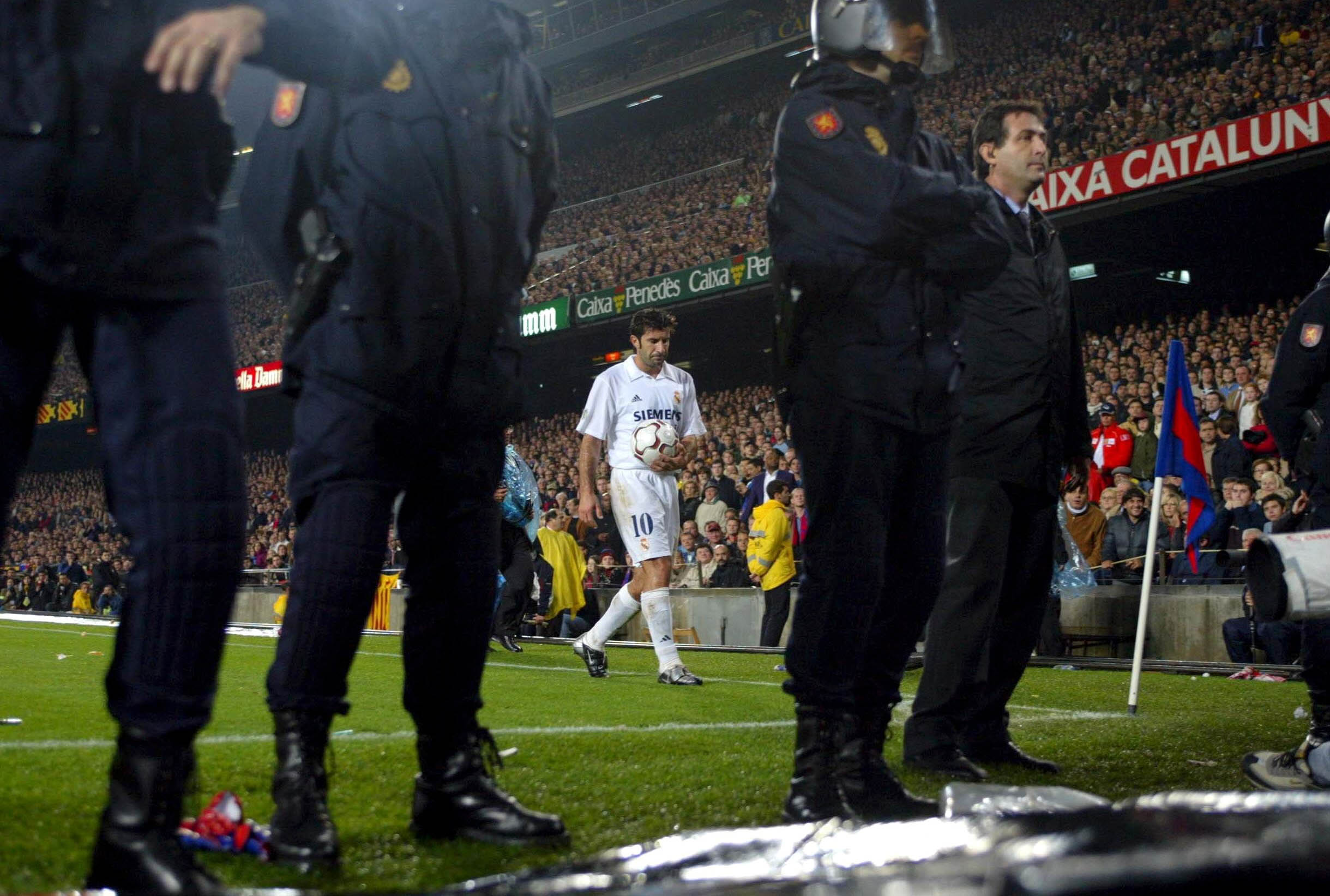 BARCELONA - NOVEMBER 23:  Luis Figo of Real Madrid prepares to take a corner with a police escort during the La Liga match between FC Barcelona and Real Madrid played at the Nou Camp Stadium, Barcelona, Spain on November 23, 2002. (Photo by Firo Foto/Gett