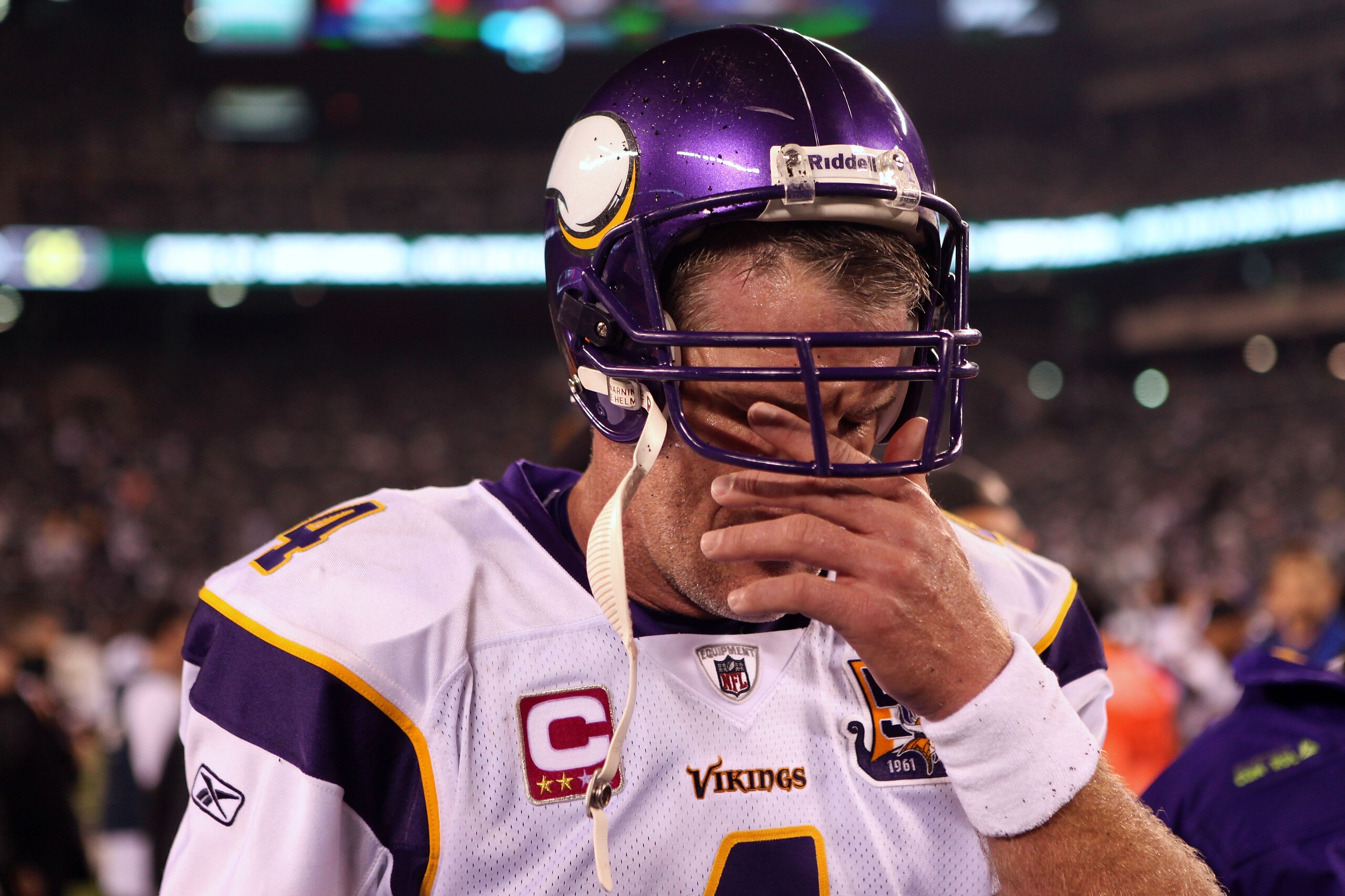 EAST RUTHERFORD, NJ - OCTOBER 11:  Brett Favre #4 of the Minnesota Vikings wipes his eyes as he walks off the field after the New York Jets won 29-20 at New Meadowlands Stadium on October 11, 2010 in East Rutherford, New Jersey.  (Photo by Andrew Burton/G