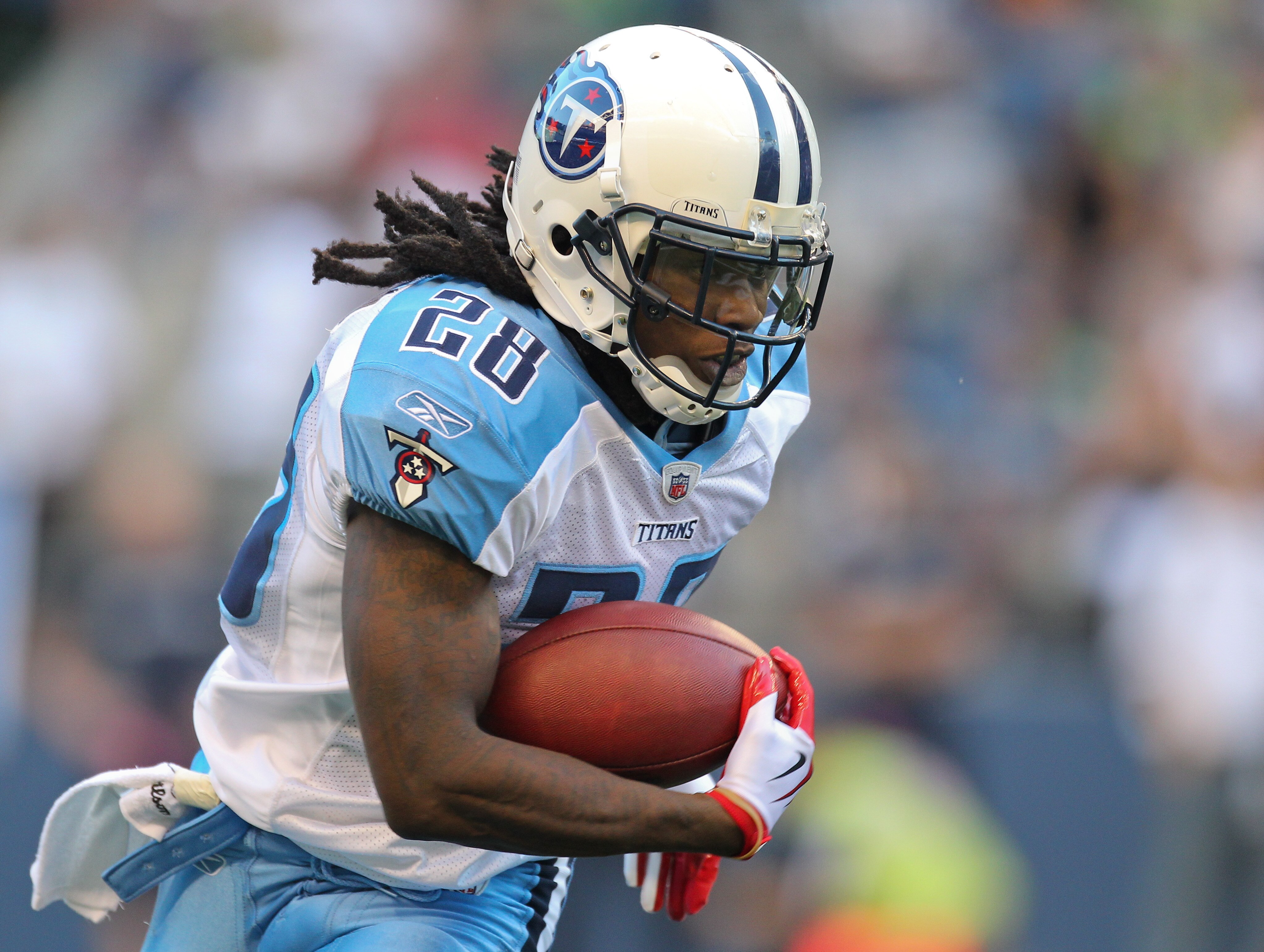 SEATTLE - AUGUST 14:  Running back Chris Johnson #28 of the Tennessee Titans rushes during the preseason game against the Seattle Seahawks at Qwest Field on August 14, 2010 in Seattle, Washington. (Photo by Otto Greule Jr/Getty Images)