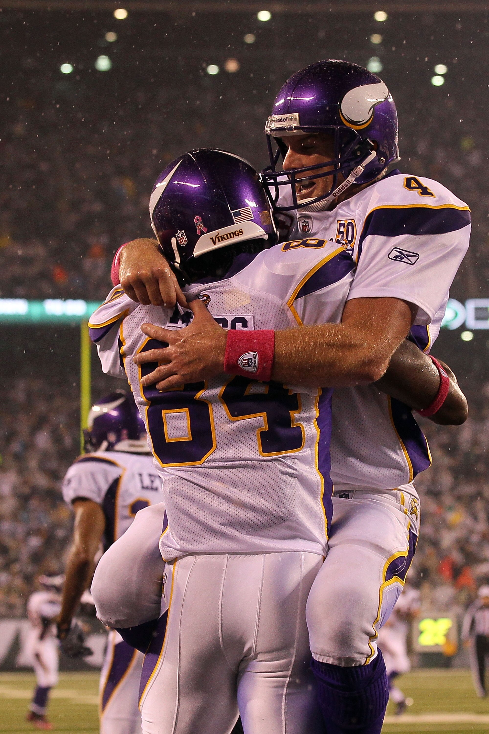 EAST RUTHERFORD, NJ - OCTOBER 11:  Brett Favre #4 and Randy Moss #84 of the Minnesota Vikings celebrate after Moss caught a 37-yard touchdown pass from Favre in the third quarter against the New York Jets at New Meadowlands Stadium on October 11, 2010 in