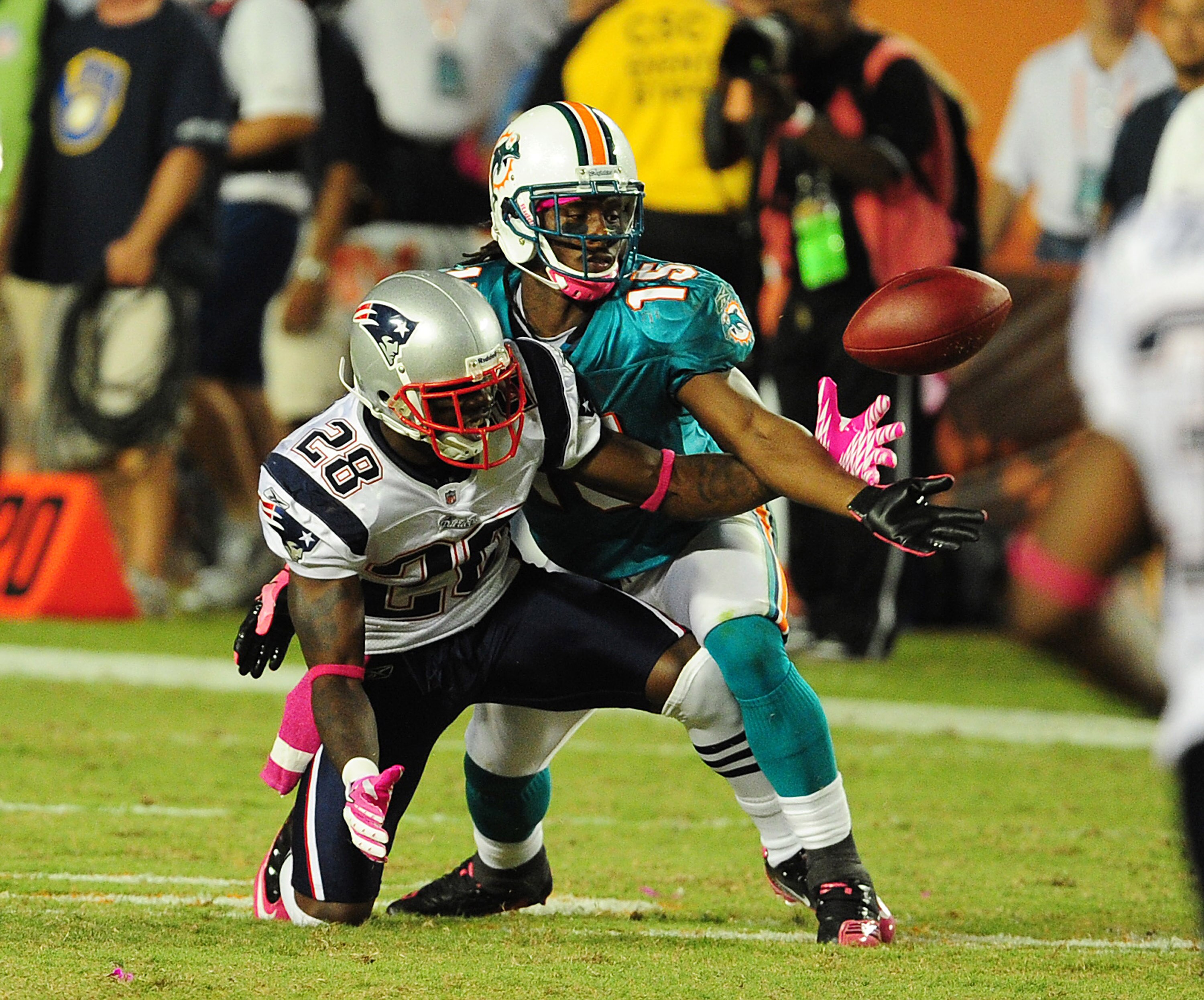 MIAMI - OCTOBER 4: Davone Bess #15 of the Miami Dolphins battles for a pass against Darius Butler #28 of the New England Patriots at Sun Life Field on October 4, 2010 in Miami, Florida. (Photo by Scott Cunningham/Getty Images)