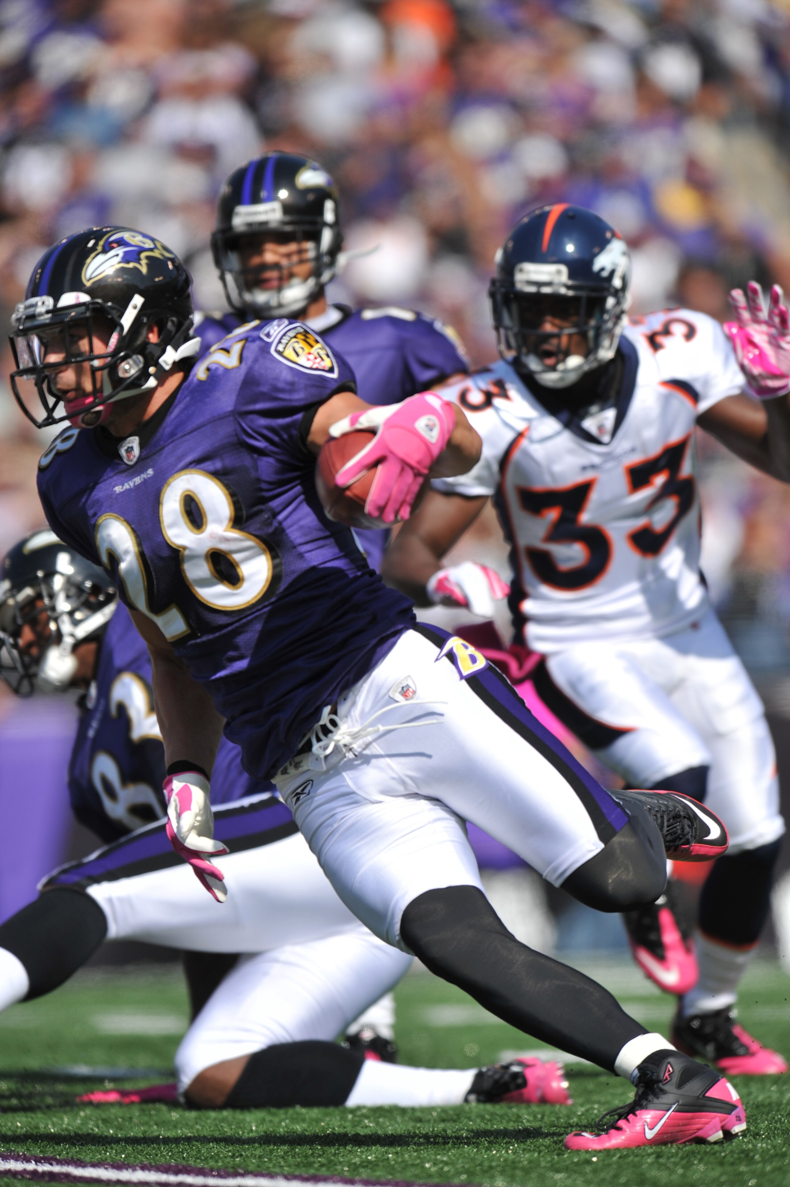 BALTIMORE, MD - OCTOBER 10:  Tom Zbikowski #28 of the Baltimore Ravens runs the ball against the Denver Broncos at M&T Bank Stadium on October 10, 2010 in Baltimore, Maryland. Players wore pink in recognition of Breast Cancer Awareness Month. The Ravens d