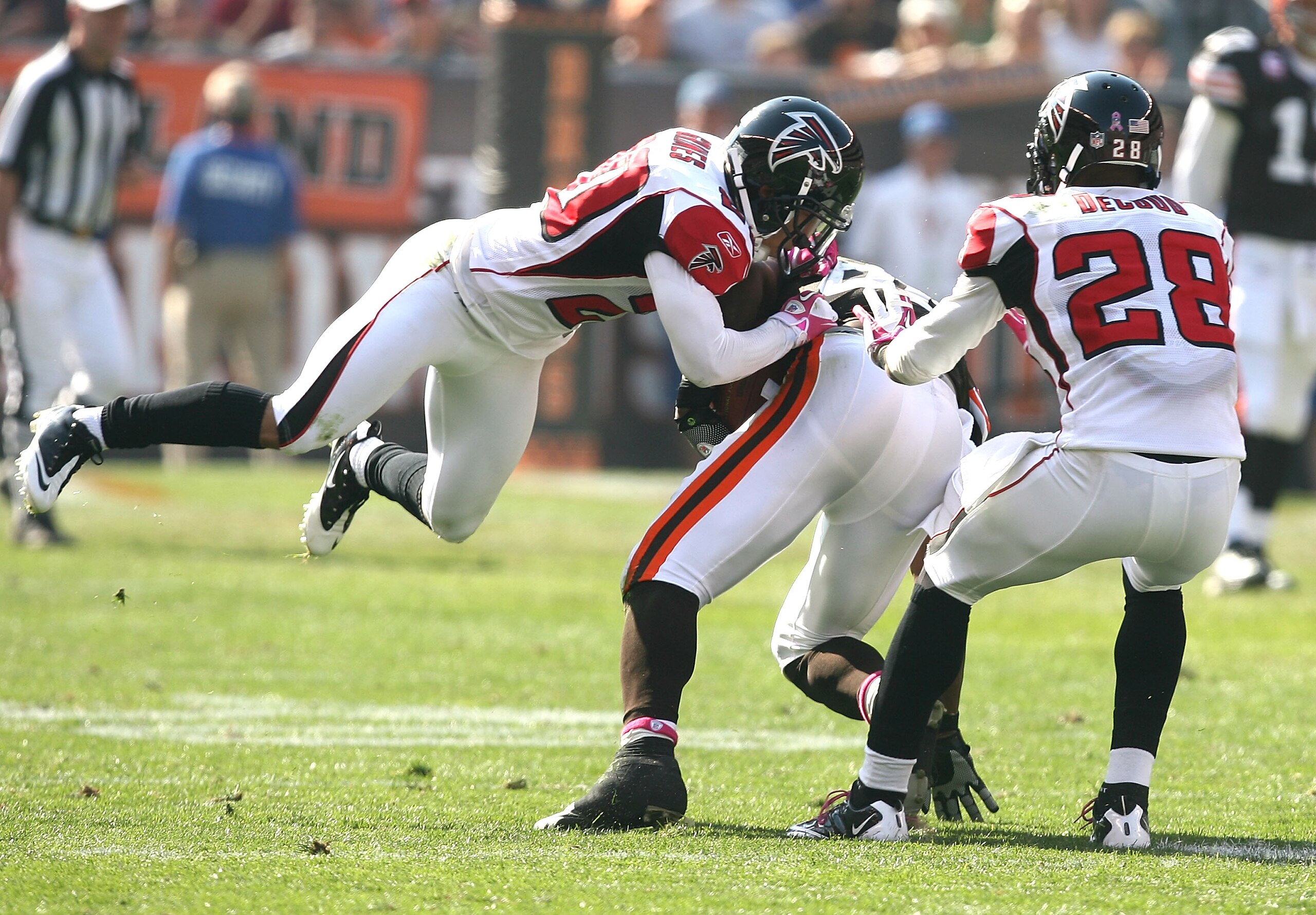 CLEVELAND - OCTOBER 10:  Tight end Benjamin Watson #82 of the Cleveland Browns is tackled by defenders Brent Grimes #20 and Thomas DeCoud #28 of the Atlanta Falcons at Cleveland Browns Stadium on October 10, 2010 in Cleveland, Ohio.  (Photo by Matt Sulliv