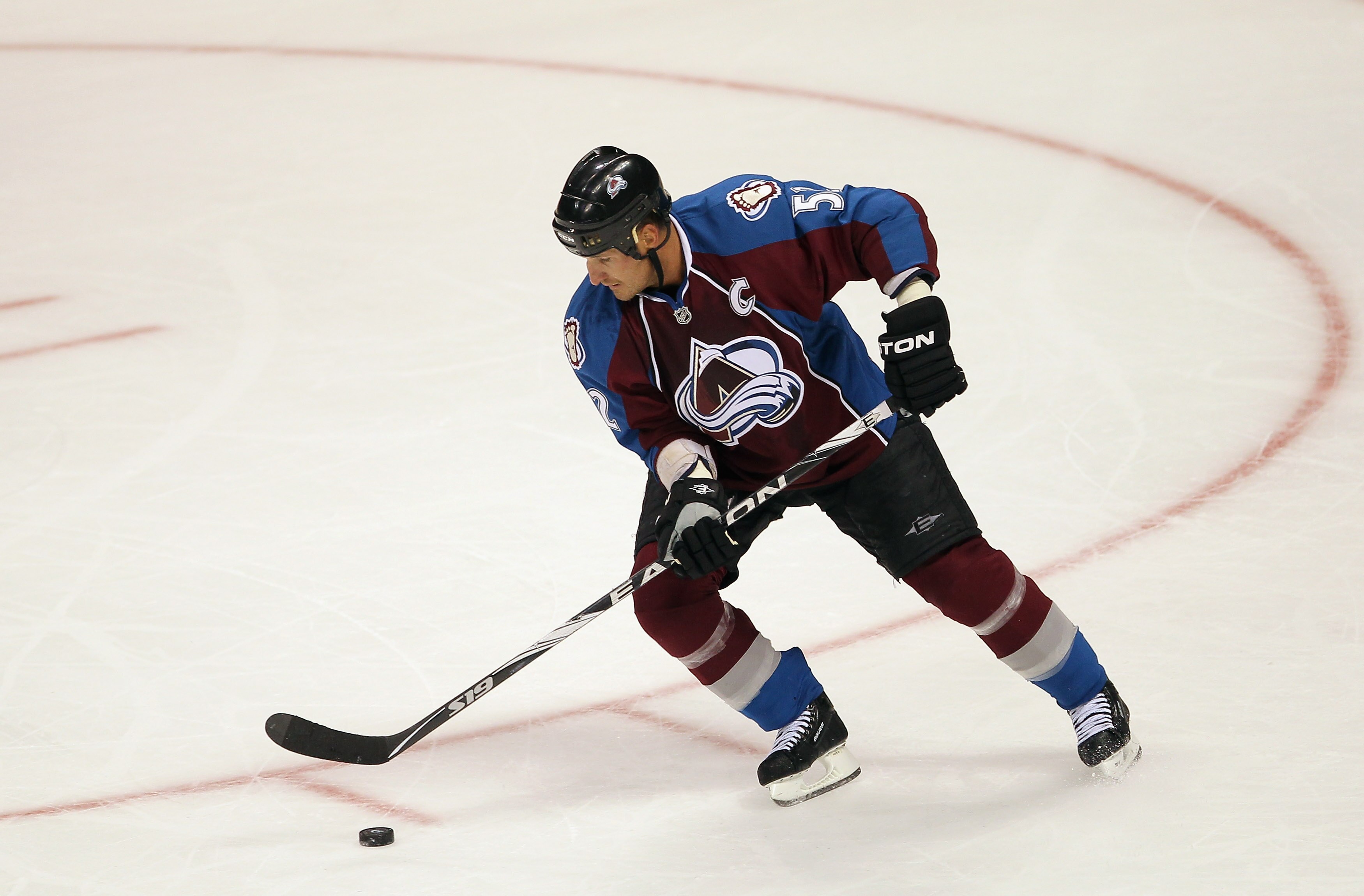 DENVER - SEPTEMBER 22:  Adam Foote #52 of the Colorado Avalanche controls the puck against the Los Angeles Kings during preseason NHL action at the Pepsi Center on September 22, 2010 in Denver, Colorado. The Kings defeated the Avalanche 4-2.  (Photo by Do