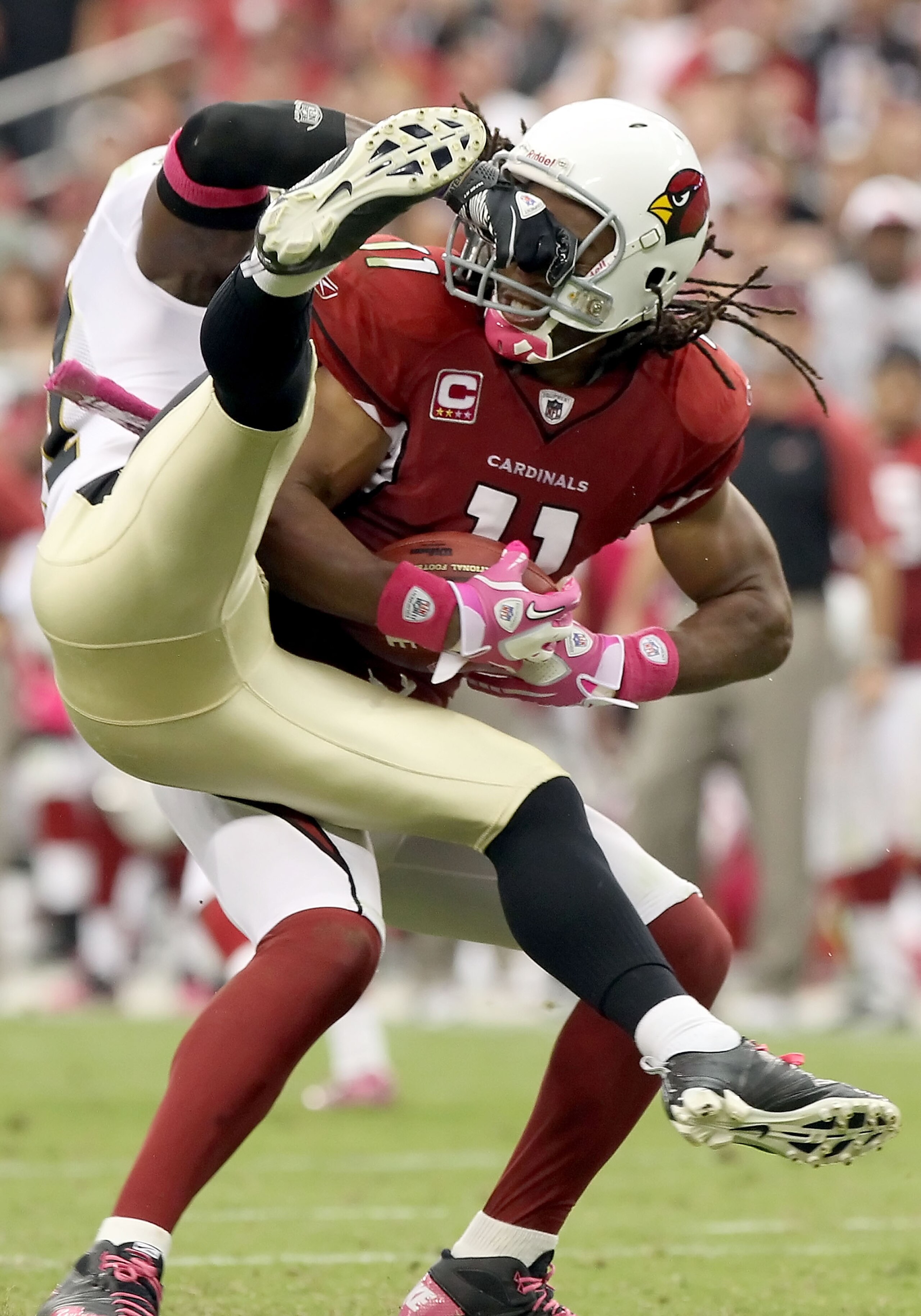 GLENDALE, AZ - OCTOBER 10:  Wide receiver Larry Fitzgerald #11 of the Arizona Cardinals gets facemasked by Malcolm Jenkins #27 of the New Orleans Saints after a 17 yard reception during the fourth quarter of the NFL game at the University of Phoenix Stadi
