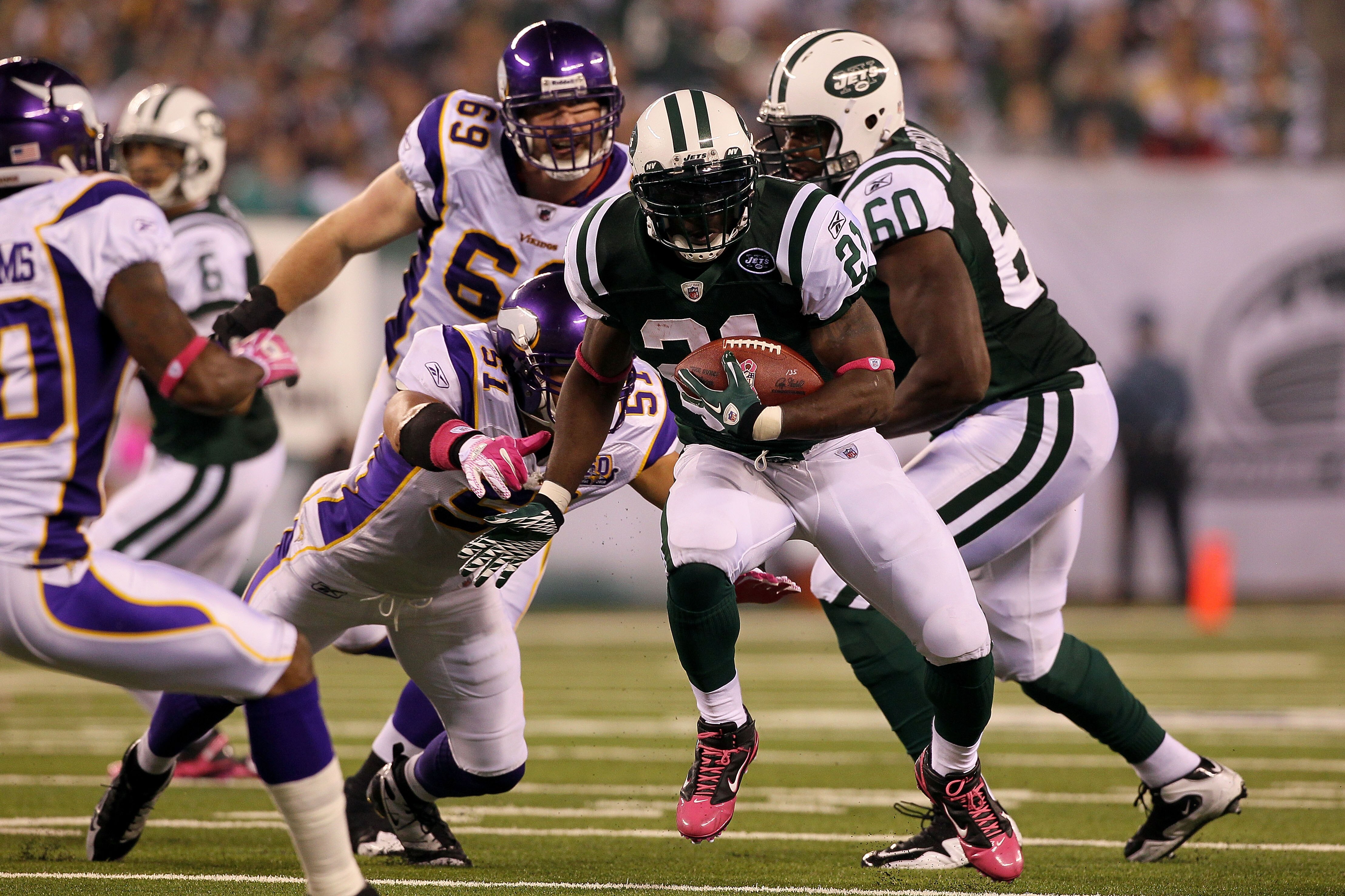 EAST RUTHERFORD, NJ - OCTOBER 11:  LaDainian Tomlinson #21 of the New York Jets runs the ball in the first half against Ben Leber #51 of the Minnesota Vikings at New Meadowlands Stadium on October 11, 2010 in East Rutherford, New Jersey.  (Photo by Jim Mc