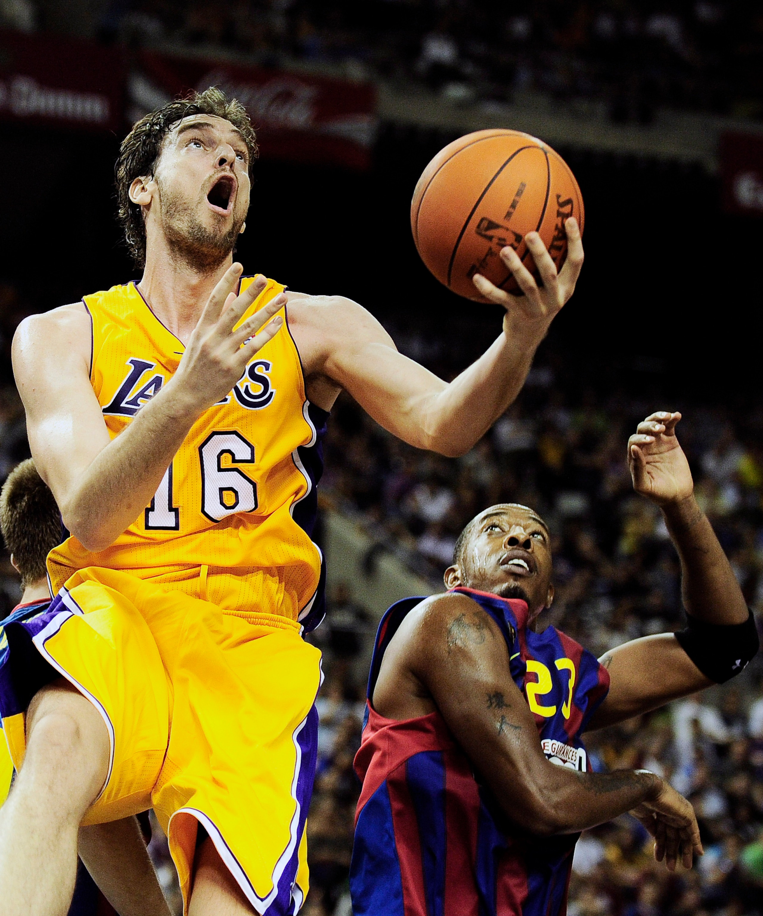 BARCELONA, SPAIN - OCTOBER 07:  Pau Gasol #16 (L) of the Los Angeles Lakers gets to the hoop against Terence Morris #23 of the Regal FC Barcelona during the NBA Europe Live match between Los Angeles Lakers and Regal FC Barcelona at the at Palau Blaugrana 