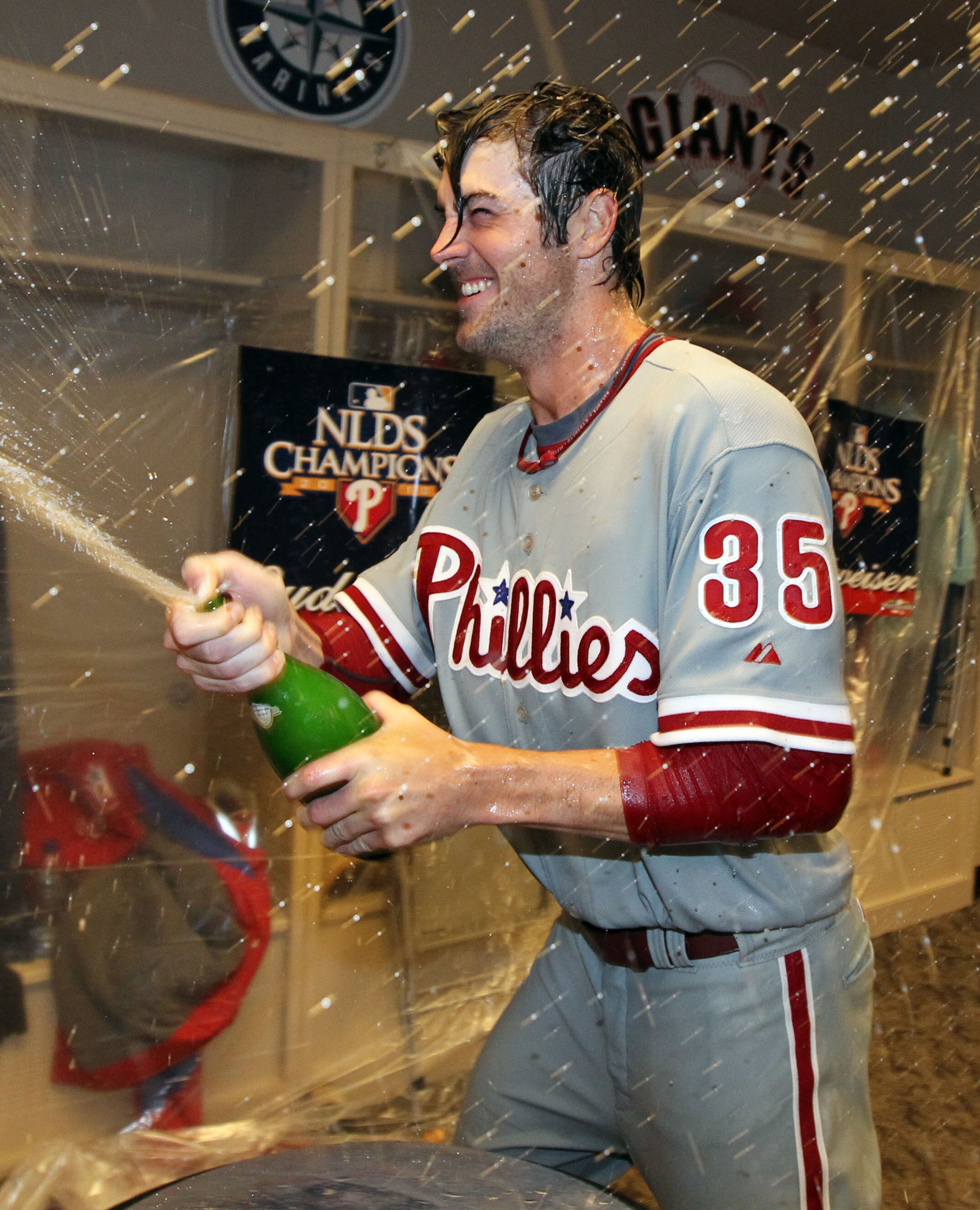 CINCINNATI - OCTOBER 10:  Cole Hamels #35 of the Philadelphia Phillies sprays champagne in the clubhouse after throwing a complete game shut-out to sweep the Cincinnati Reds during Game 3 of the NLDS at Great American Ball Park on October 10, 2010 in Cinc