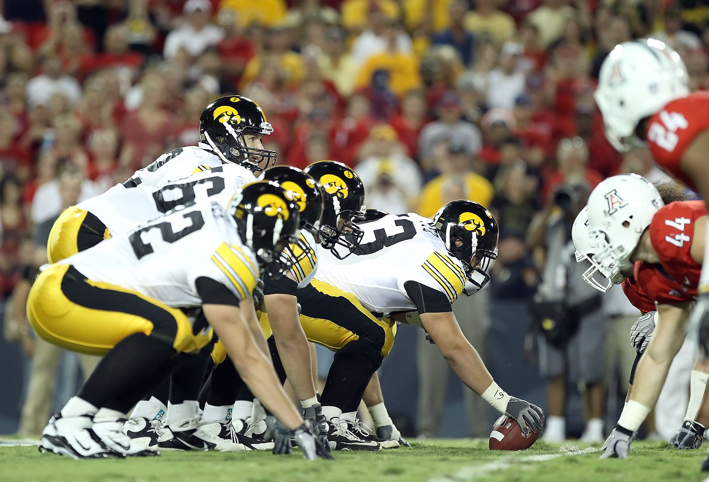 TUCSON, AZ - SEPTEMBER 18:  Quarterback Ricky Stanzi #12 of the Iowa Hawkeyes prepares to snap the ball during the college football game against the Arizona Wildcats at Arizona Stadium on September 18, 2010 in Tucson, Arizona.  The Wildcats defeated the H