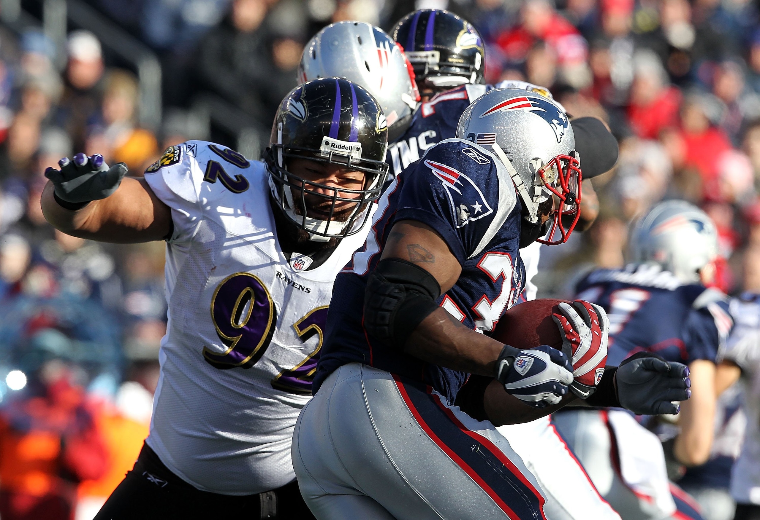 FOXBORO, MA - JANUARY 10:  Haloti Ngata #92 of the Baltimore Ravens attempts to stop Kevin Faulk #33 of the New England Patriots during the 2010 AFC wild-card playoff game at Gillette Stadium on January 10, 2010 in Foxboro, Massachusetts. The Ravens won 3
