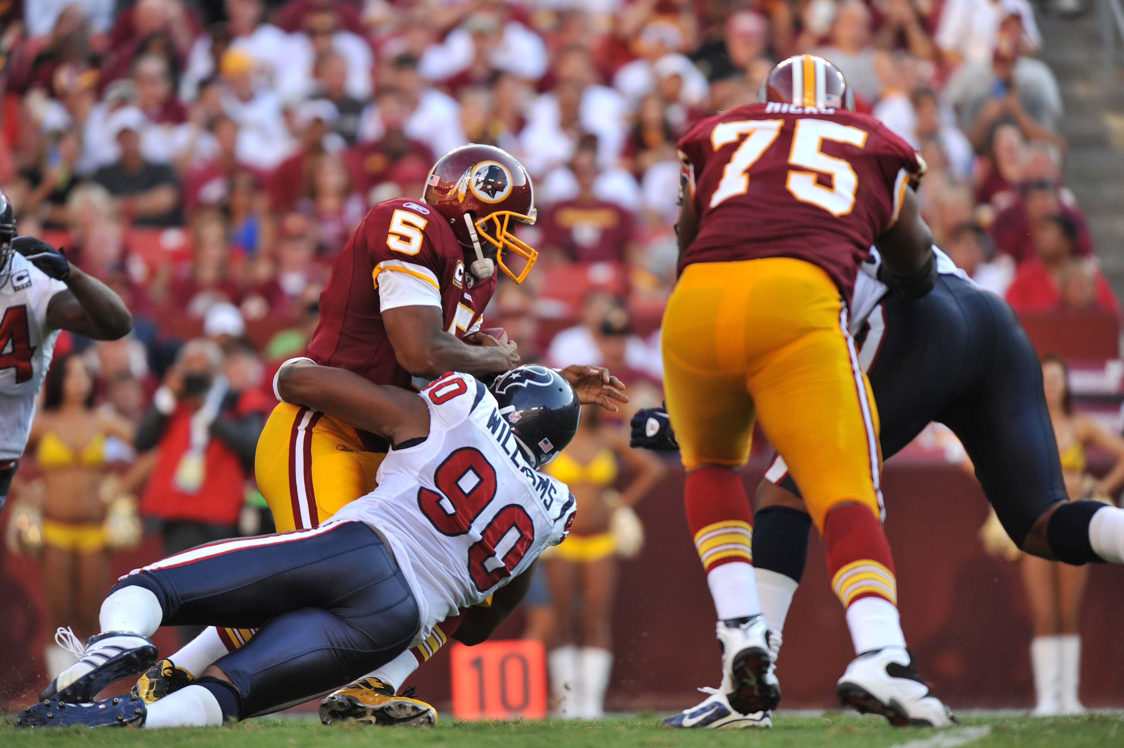 LANDOVER - SEPTEMBER 19:  Mario Williams #90 of the Houston Texans sacks Donovan McNabb #5 of the Washington Redskins at FedExField on September 19, 2010 in Landover, Maryland. The Texans defeated the Redskins 30-27 in overtime. (Photo by Larry French/Get