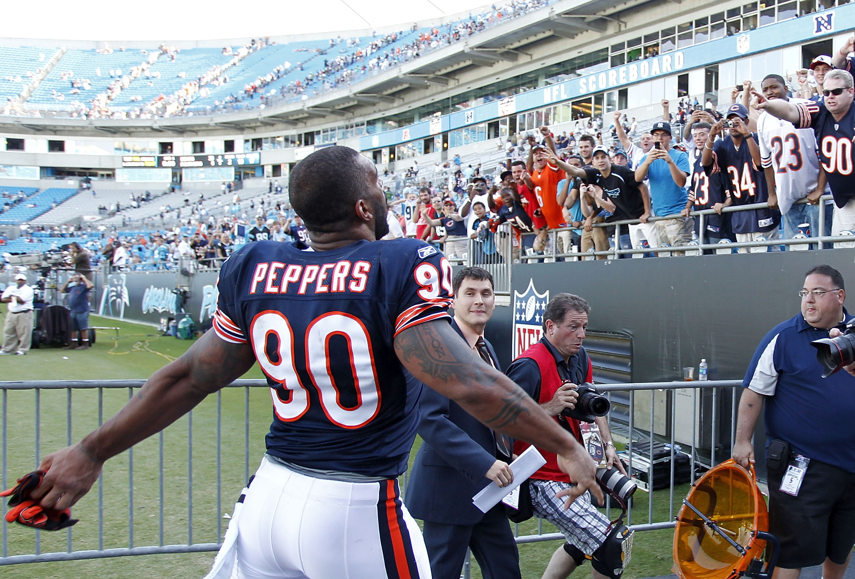 CHARLOTTE, NC - OCTOBER 10: Defensive end Julius Peppers #90 of the Chicago Bears throws his gloves into the stands as he leaves the field after the Bears game against the Carolina Panthers at Bank of America Stadium on October 10, 2010 in Charlotte, Nort