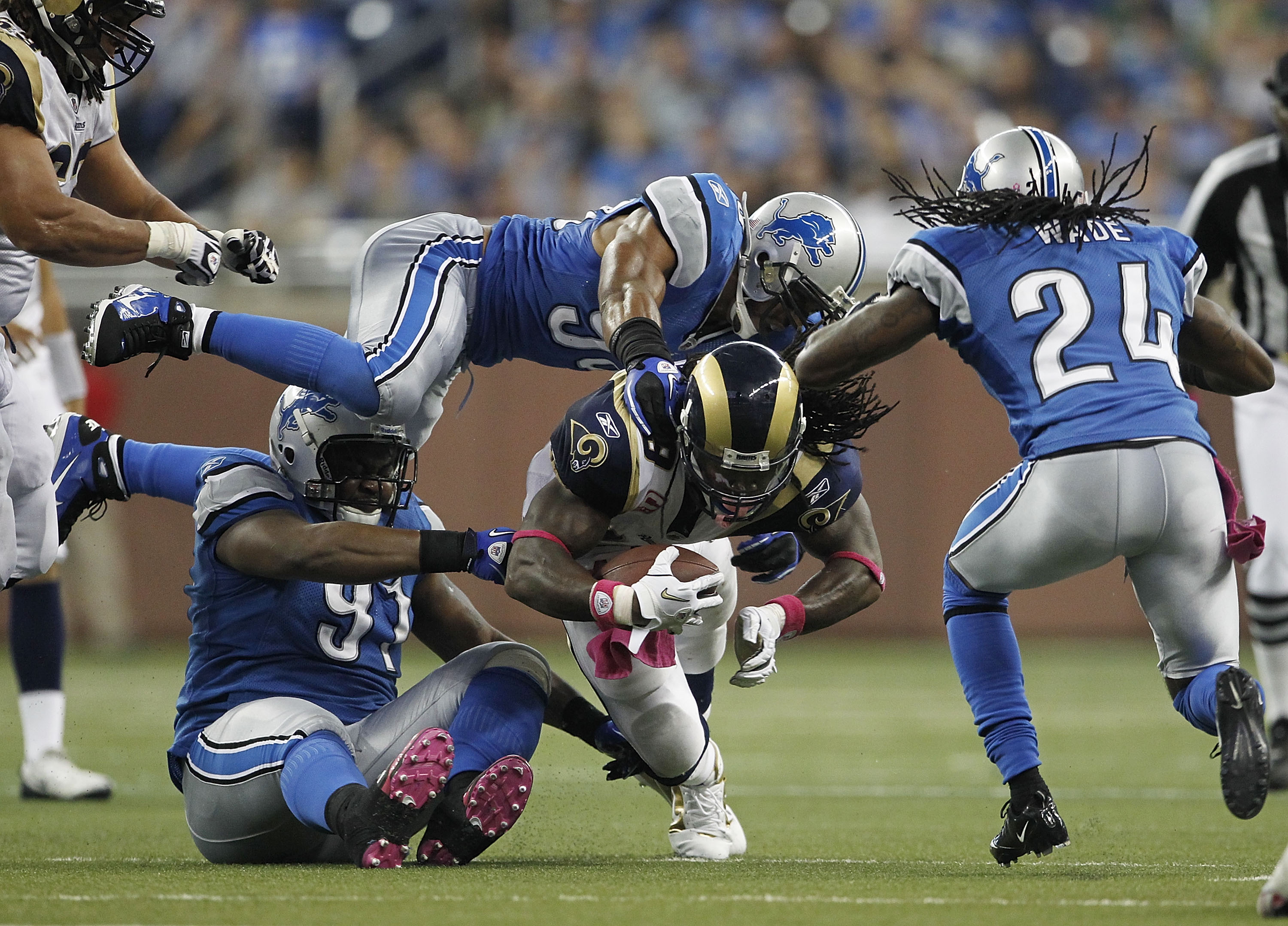 DETROIT - OCTOBER 10: Steven Jackson #39 of the St. Louis Rams runs for a short gain in the third quarter as Julian Peterson #98 and and Sammie Hill #91 of the Detroit Lions make the stop during the game at Ford Field on October 10, 2010 in Detroit, Michi