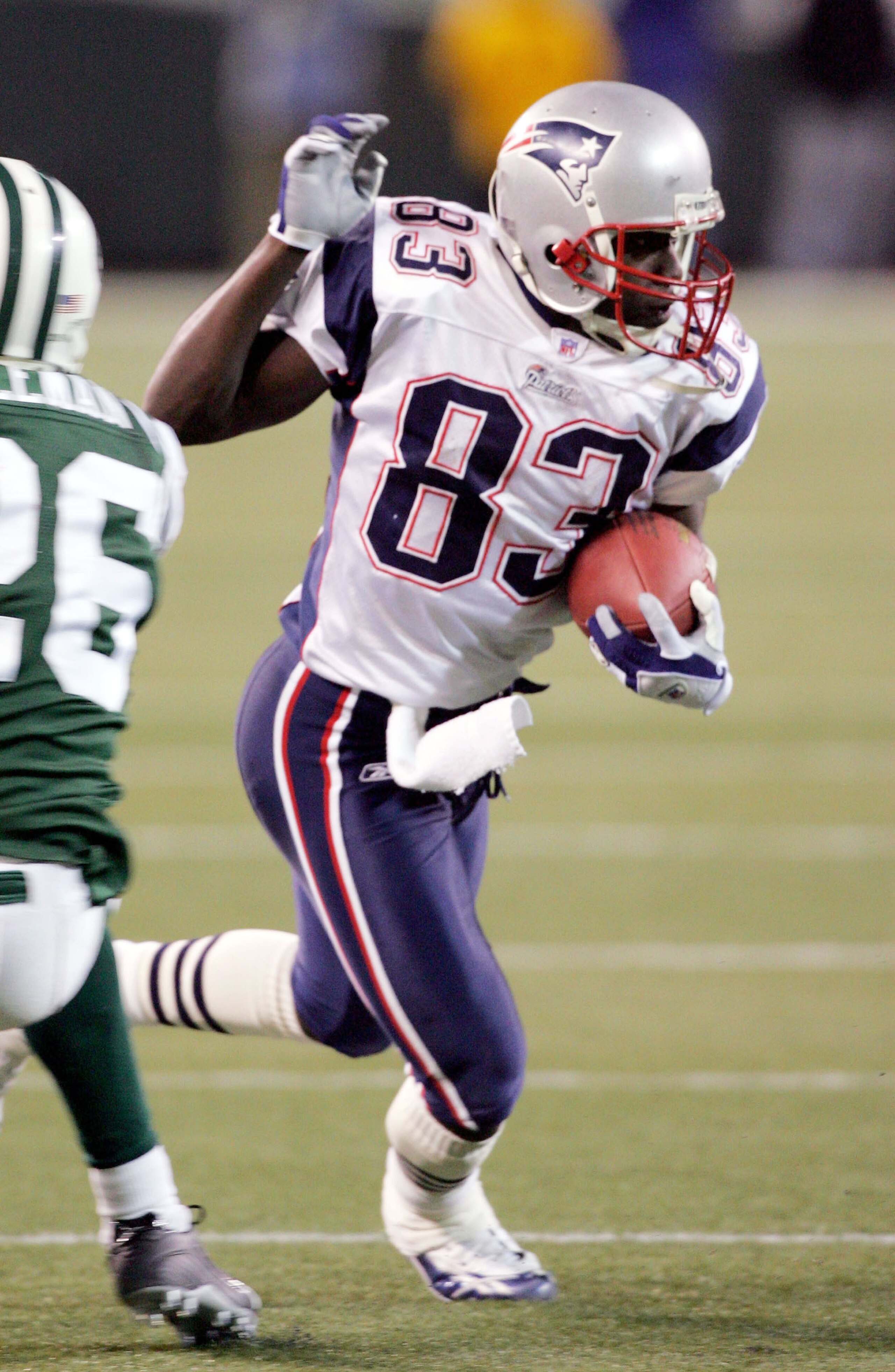 EAST RUTHERFORD, NJ - DECEMBER 26: Deion Branch #83 of the New England Patriots runs the ball past Erik Coleman #26 of the New York Jets after a reception during the game on December 26, 2005 at Giants Stadium in East Rutherford, New Jersey. The Patriots EAST RUTHERFORD, NJ - DECEMBER 26: Deion Branch #83 of the New England Patriots runs the ball past Erik Coleman #26 of the New York Jets after a reception during the game on December 26, 2005 at Giants Stadium in East Rutherford, New Jersey. The Patriots