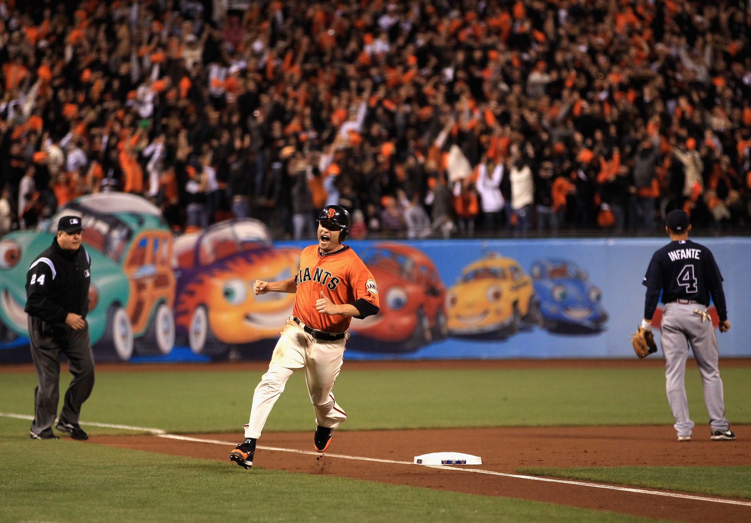 SAN FRANCISCO - OCTOBER 08:  Freddy Sanchez #21 of the San Francisco Giants reacts as he rounds third base on a home run by Pat Burrell #9 in the first inning against the Atlanta Braves in game 2 of the NLDS at AT&T Park on October 8, 2010 in San Francisc