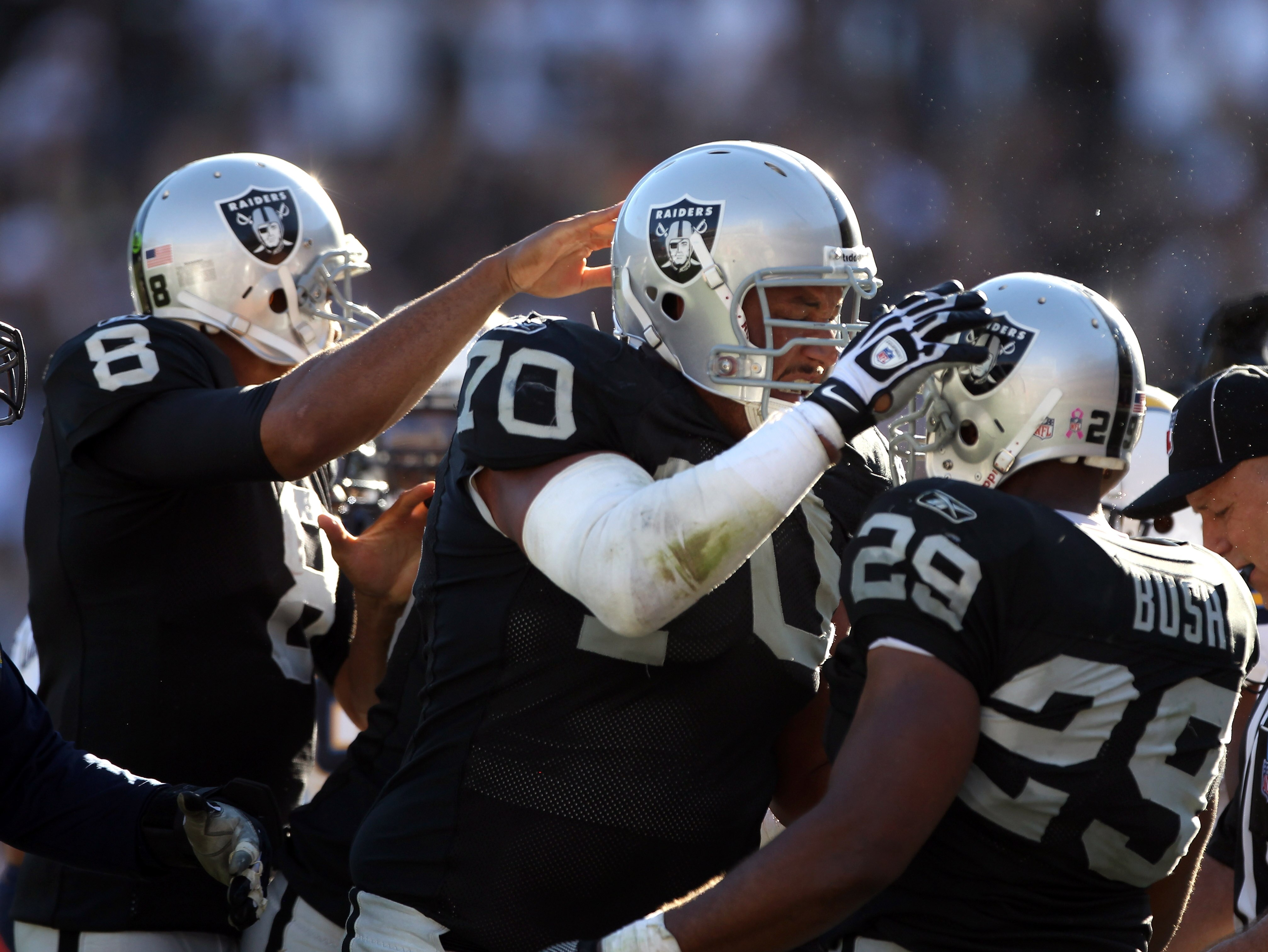 OAKLAND, CA - OCTOBER 10:  Michael Bush #29 is congratulated by Langston Walker #70 and Jason Campbell #8 of the Oakland Raiders after Bush scored a touchdwon against the San Diego Chargers at Oakland-Alameda County Coliseum on October 10, 2010 in Oakland