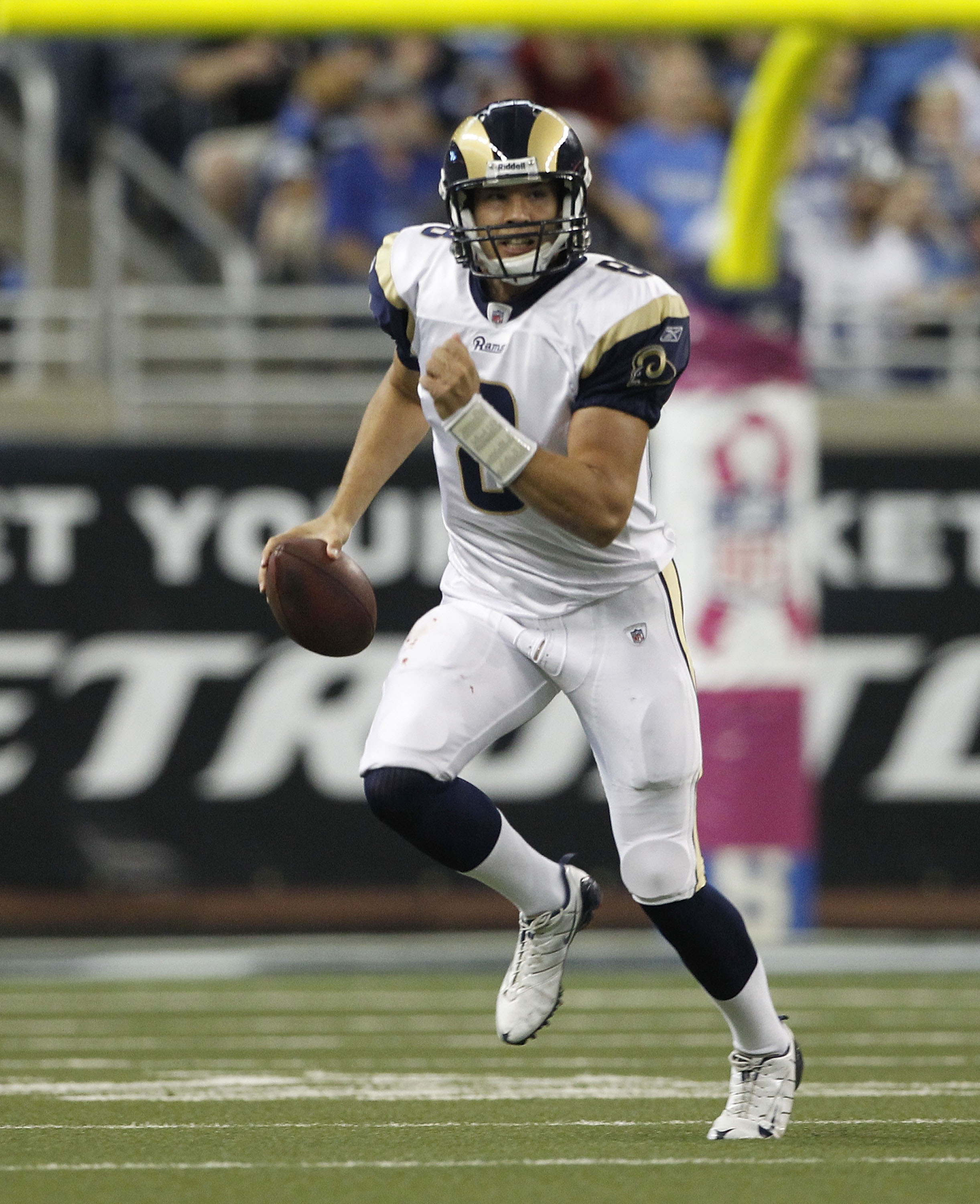 DETROIT - OCTOBER 10:  Sam Bradford #8 of the St. Louis Rams roles out to pass during the first quarter of the game against the Detroit Lions at Ford Field on October 10, 2010 in Detroit, Michigan.  (Photo by Leon Halip/Getty Images)