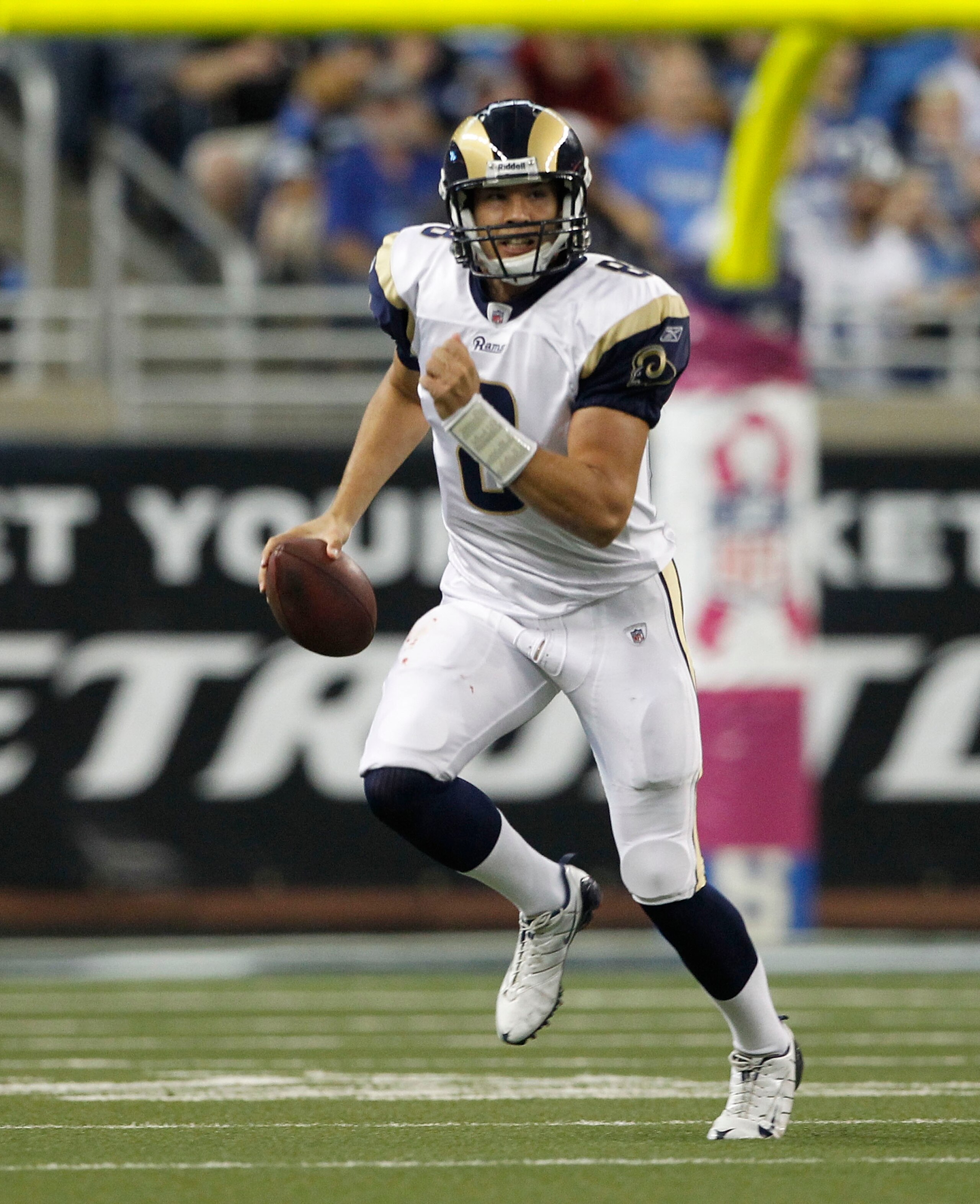 DETROIT - OCTOBER 10:  Sam Bradford #8 of the St. Louis Rams roles out to pass during the first quarter of the game against the Detroit Lions at Ford Field on October 10, 2010 in Detroit, Michigan.  (Photo by Leon Halip/Getty Images)