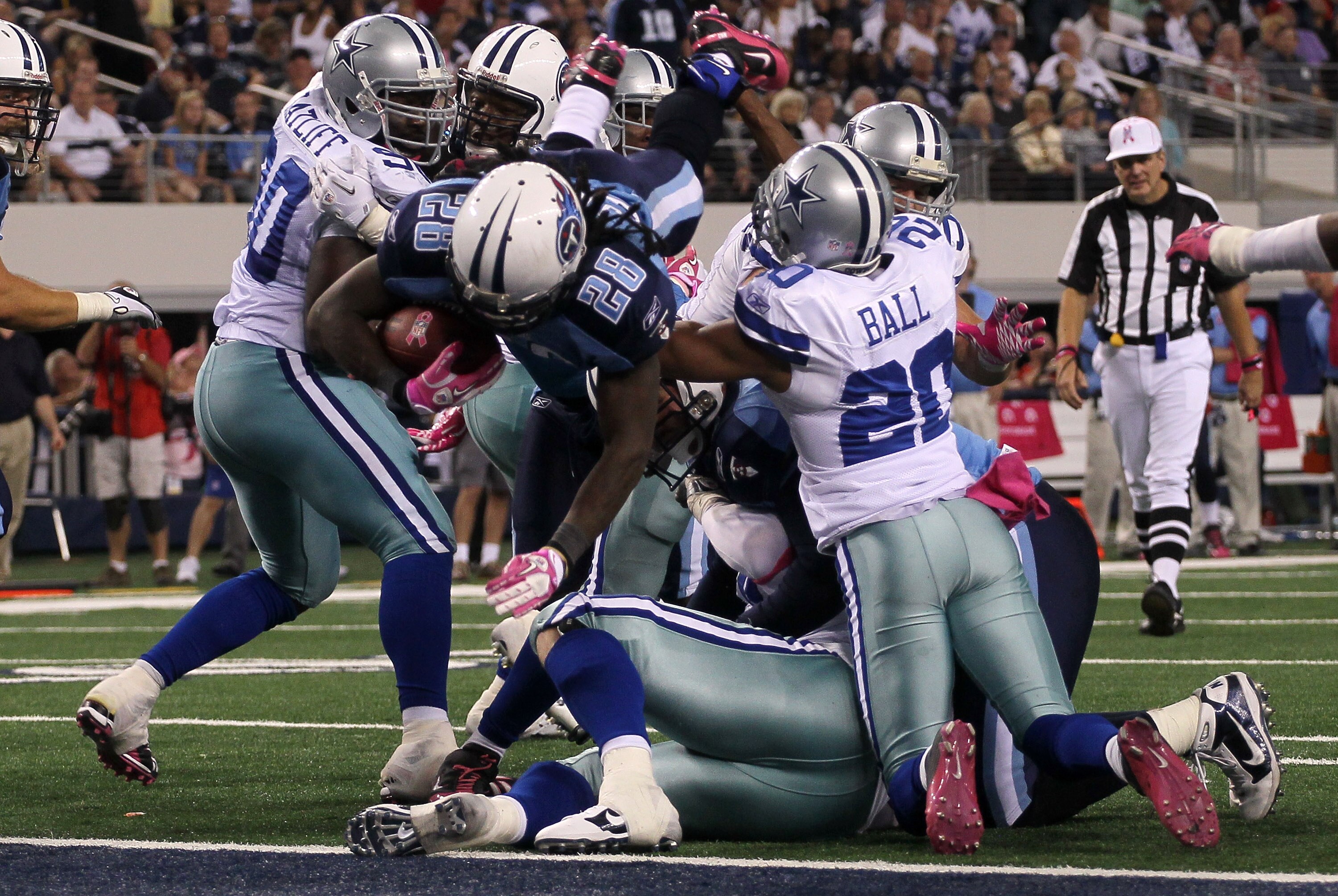 ARLINGTON, TX - OCTOBER 10:  Running back Chris Johnson #28 of the Tennessee Titans dives over the line to score the winning touchdown in the fourth quarter against the Dallas Cowboys at Cowboys Stadium on October 10, 2010 in Arlington, Texas.   The Titan