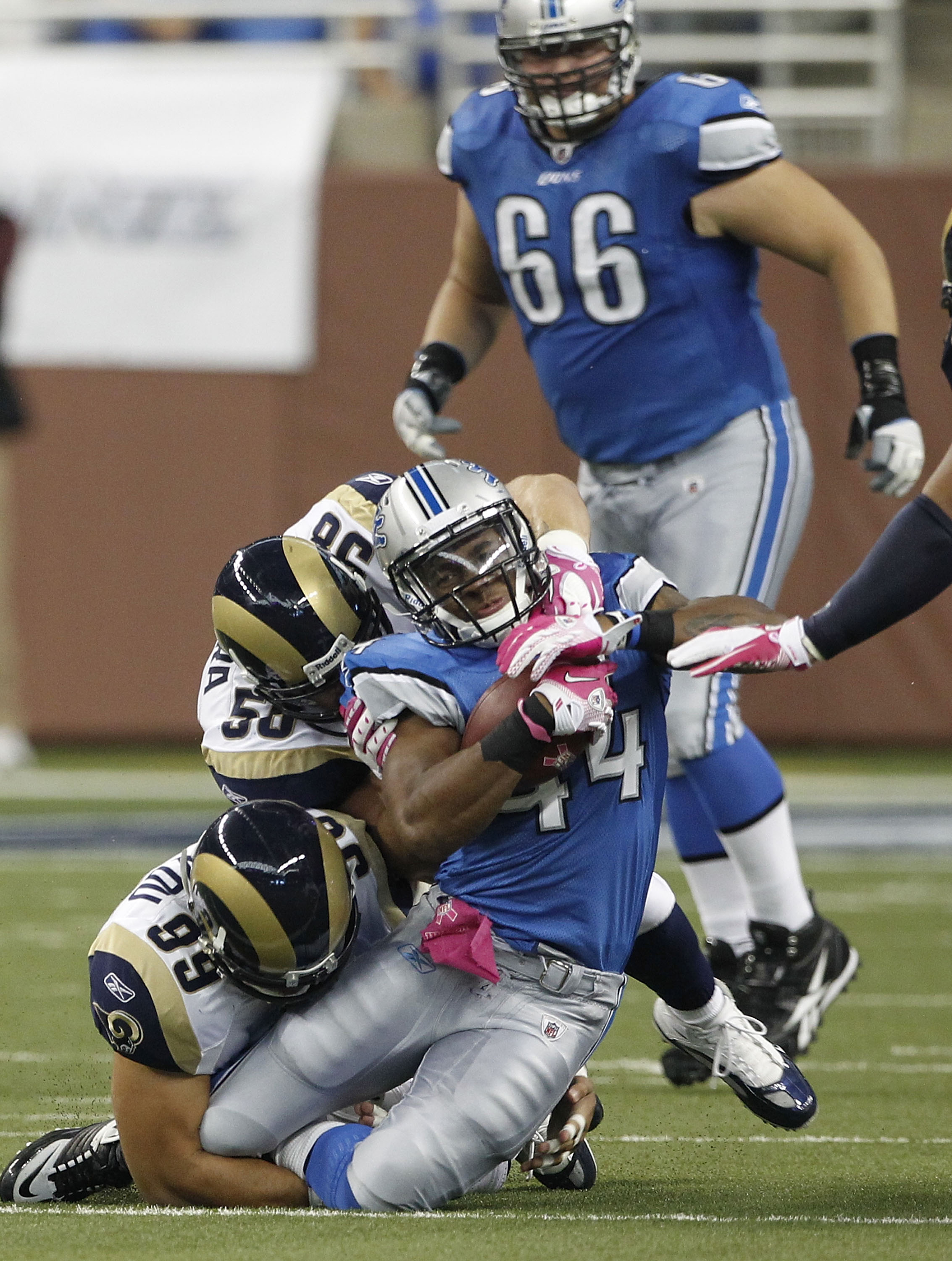 DETROIT - OCTOBER 10: Jahvid Best #44 of the Detroit Lions is tackled by C.J. Ah You #99 and David Vobora #58  of the St. Louis Rams during the second quarter of the game at Ford Field on October 10, 2010 in Detroit, Michigan.  (Photo by Leon Halip/Getty 