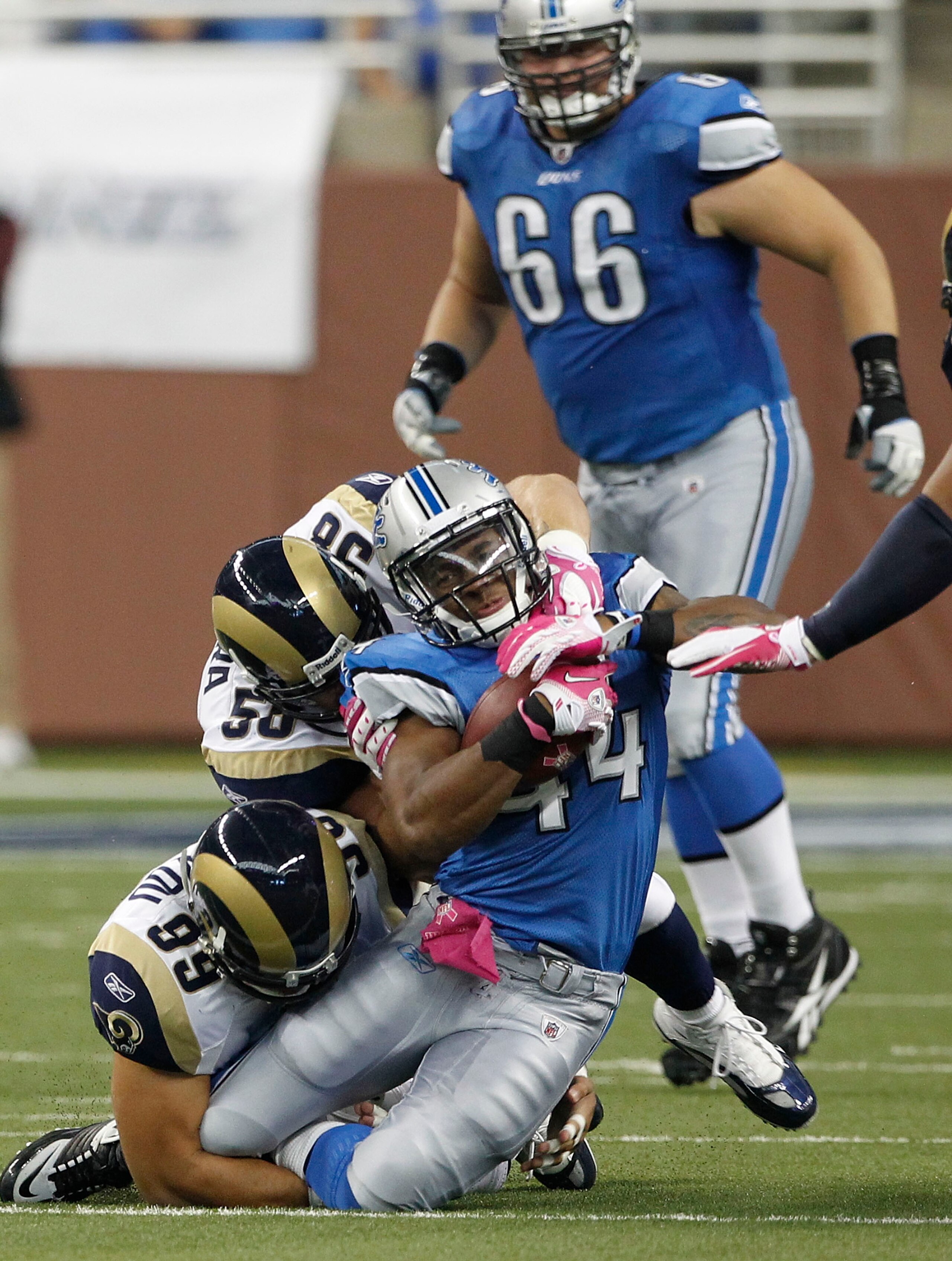 DETROIT - OCTOBER 10: Jahvid Best #44 of the Detroit Lions is tackled by C.J. Ah You #99 and David Vobora #58  of the St. Louis Rams during the second quarter of the game at Ford Field on October 10, 2010 in Detroit, Michigan.  (Photo by Leon Halip/Getty 