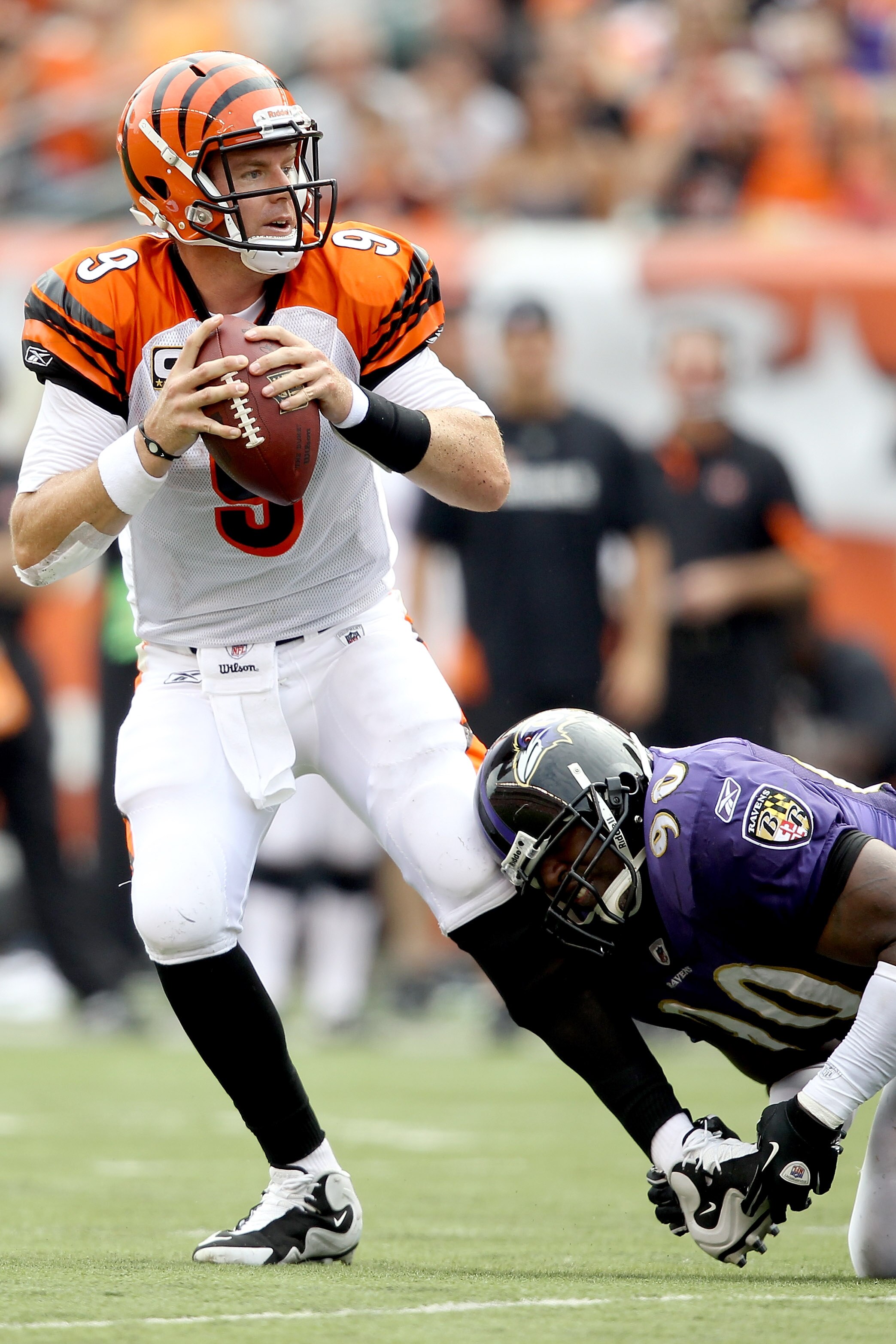 CINCINNATI - SEPTEMBER 19:  Quarterback Carson Palmer #9 of the Cincinnati Bengals tries to break free from Trevor Pryce #90 of the Baltimore Ravens at Paul Brown Stadium on September 19, 2010 in Cincinnati, Ohio.  (Photo by Matthew Stockman/Getty Images)