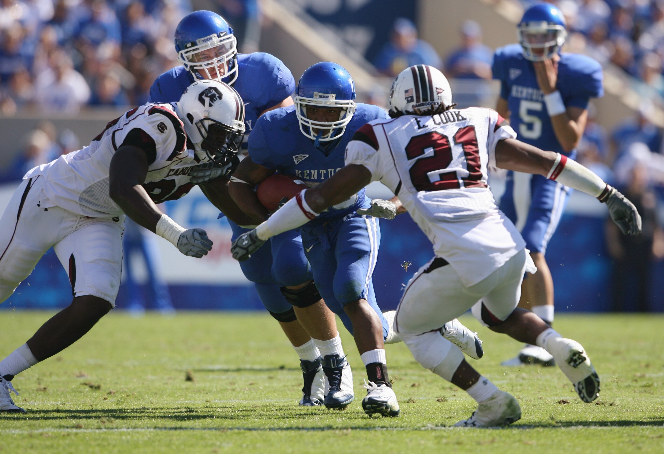 LEXINGTON, KY - OCTOBER 11:  Derrick Locke #20 of the Kentucky Wildcats runs the ball against Emanuel Cook #21 of the South Carolina Gamecocks during the game at Commonwealth Stadium on October 11, 2008 in Lexington, Kentucky. South Carolina defeated Kent