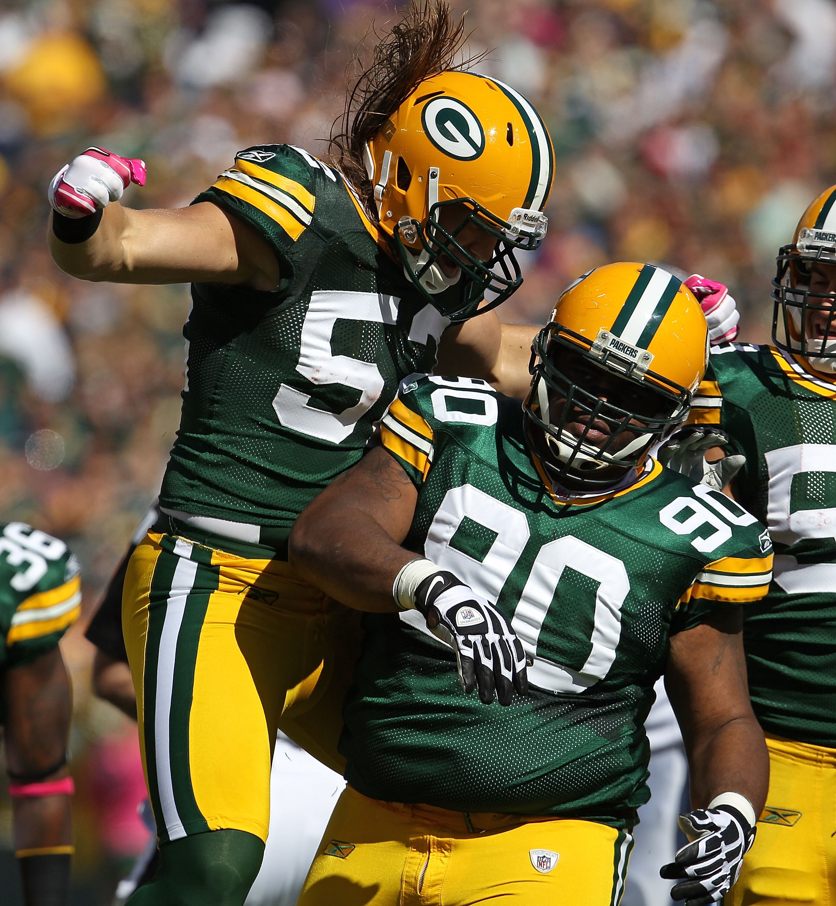 GREEN BAY, WI - OCTOBER 03: Clay Matthews #52 of the Green Bay Packers celebrates a sack by teammate B.J. Raji #90 against the Detroit Lions at Lambeau Field on October 3, 2010 in Green Bay, Wisconsin. The Packers defeated the Lions 28-26. (Photo by Jonat