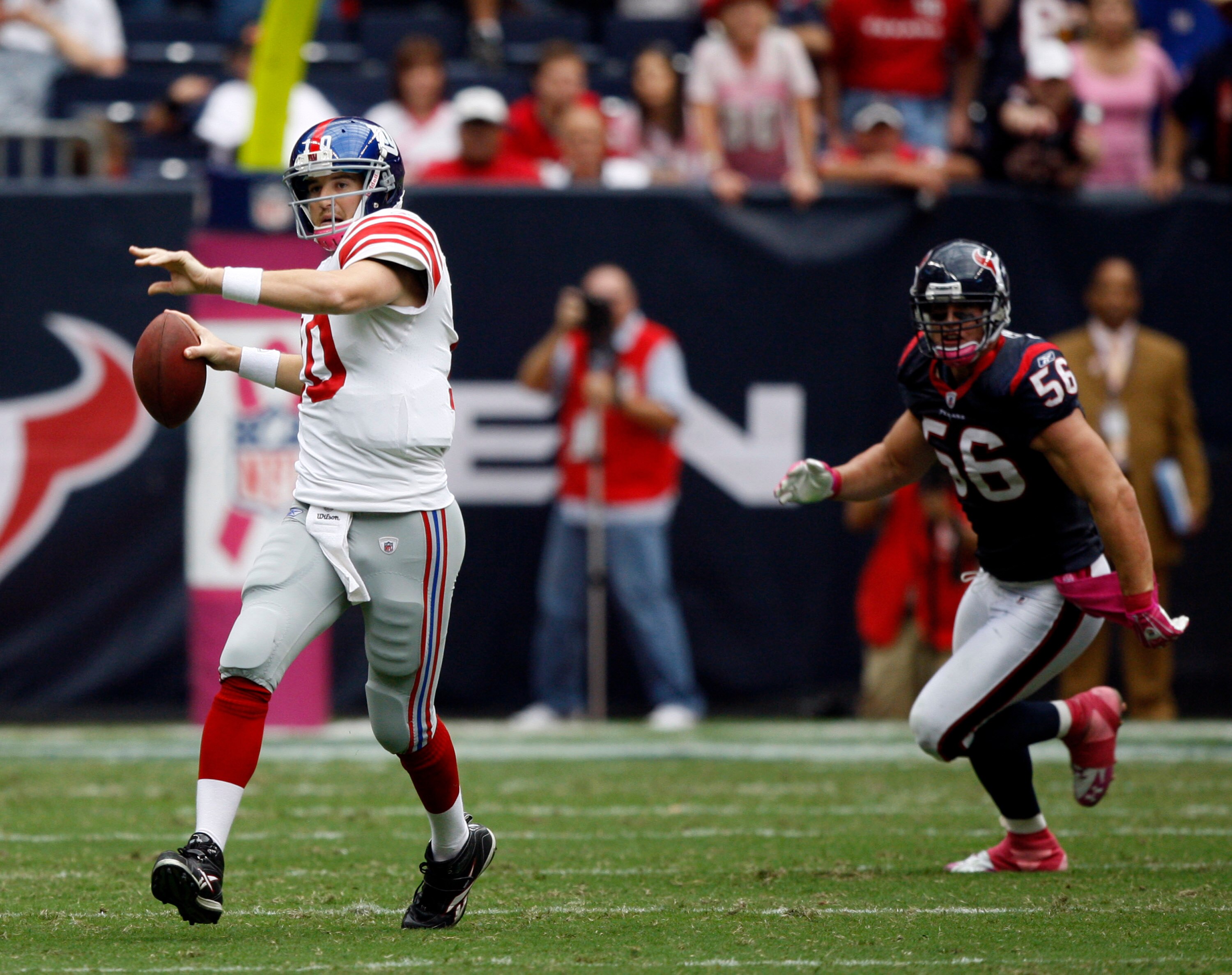 HOUSTON - OCTOBER 10:  Quarterback Eli Manning #10 of the New York Giants throws downfield before linebacker Brian Cushing #56 can get to him at Reliant Stadium on October 10, 2010 in Houston, Texas. New York won 34-10.  (Photo by Bob Levey/Getty Images)