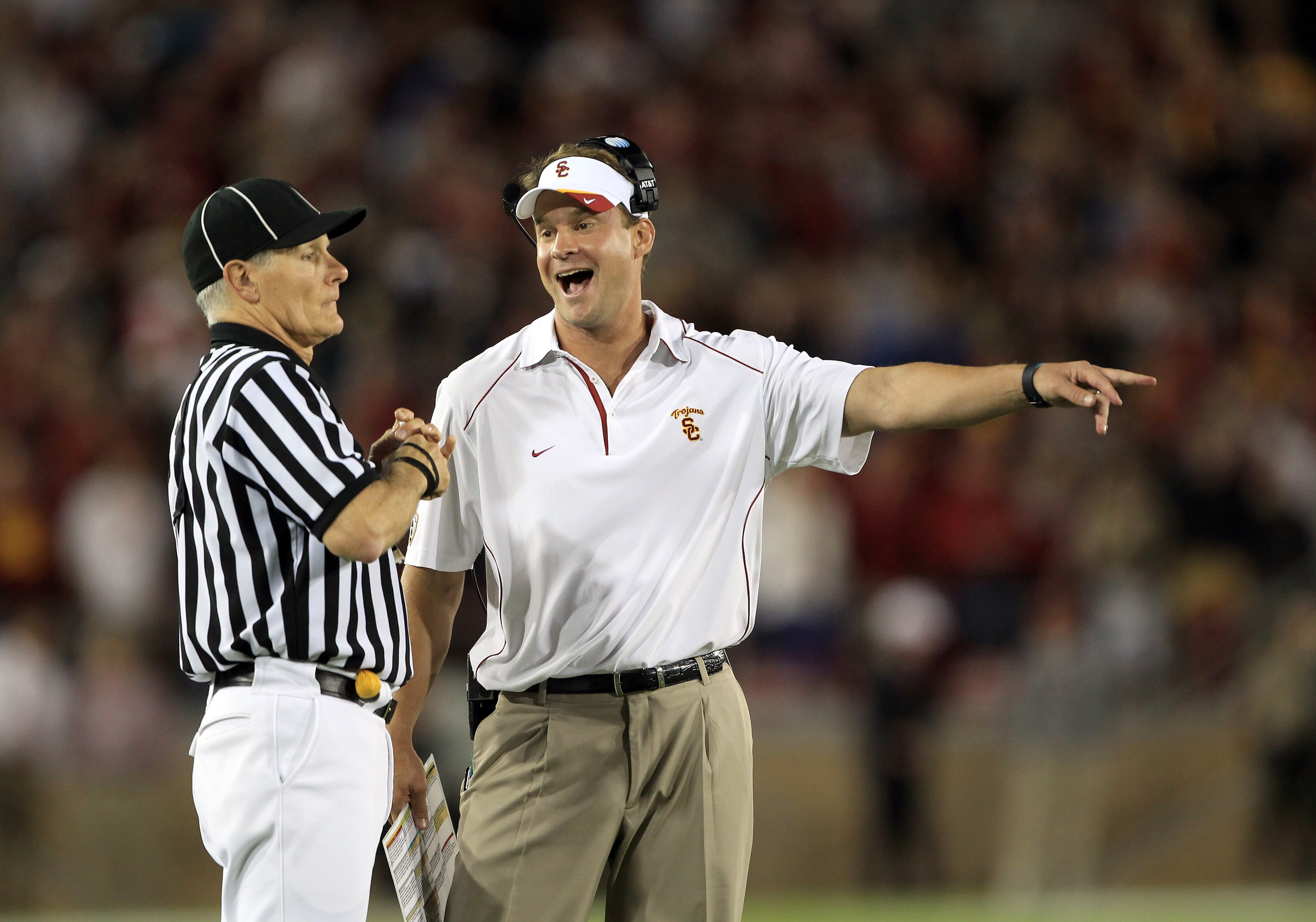 PALO ALTO, CA - OCTOBER 09:  USC Trojans head coach Lane Kiffin speaks with side judge Mike Weseloh during their loss to the Stanford Cardinal at Stanford Stadium on October 9, 2010 in Palo Alto, California.  (Photo by Ezra Shaw/Getty Images)
