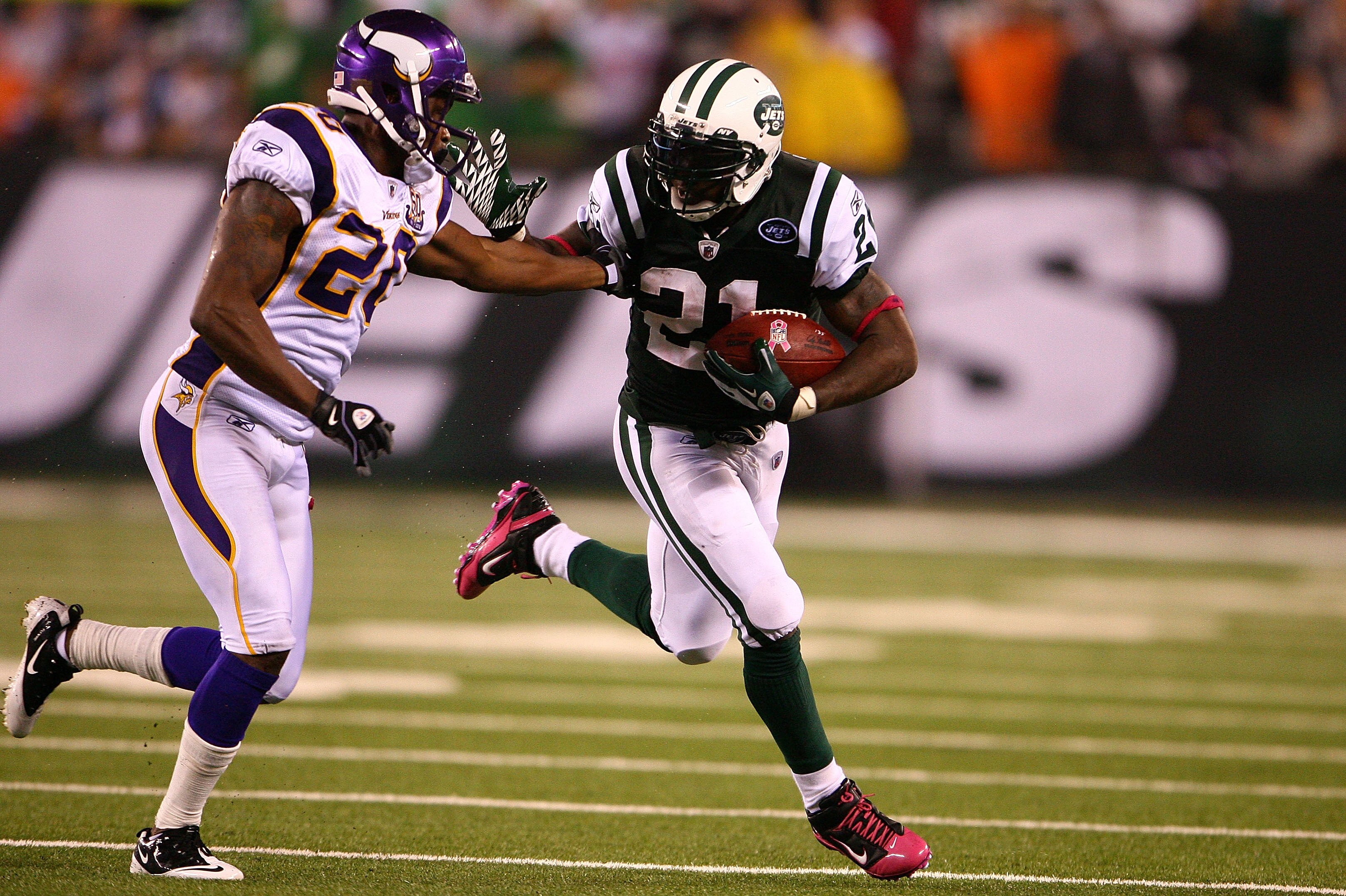 EAST RUTHERFORD, NJ - OCTOBER 11:  LaDainian Tomlinson #21 of the New York Jets runs the ball against Madieu Williams #20 of the Minnesota Vikings at New Meadowlands Stadium on October 11, 2010 in East Rutherford, New Jersey.  (Photo by Andrew Burton/Gett