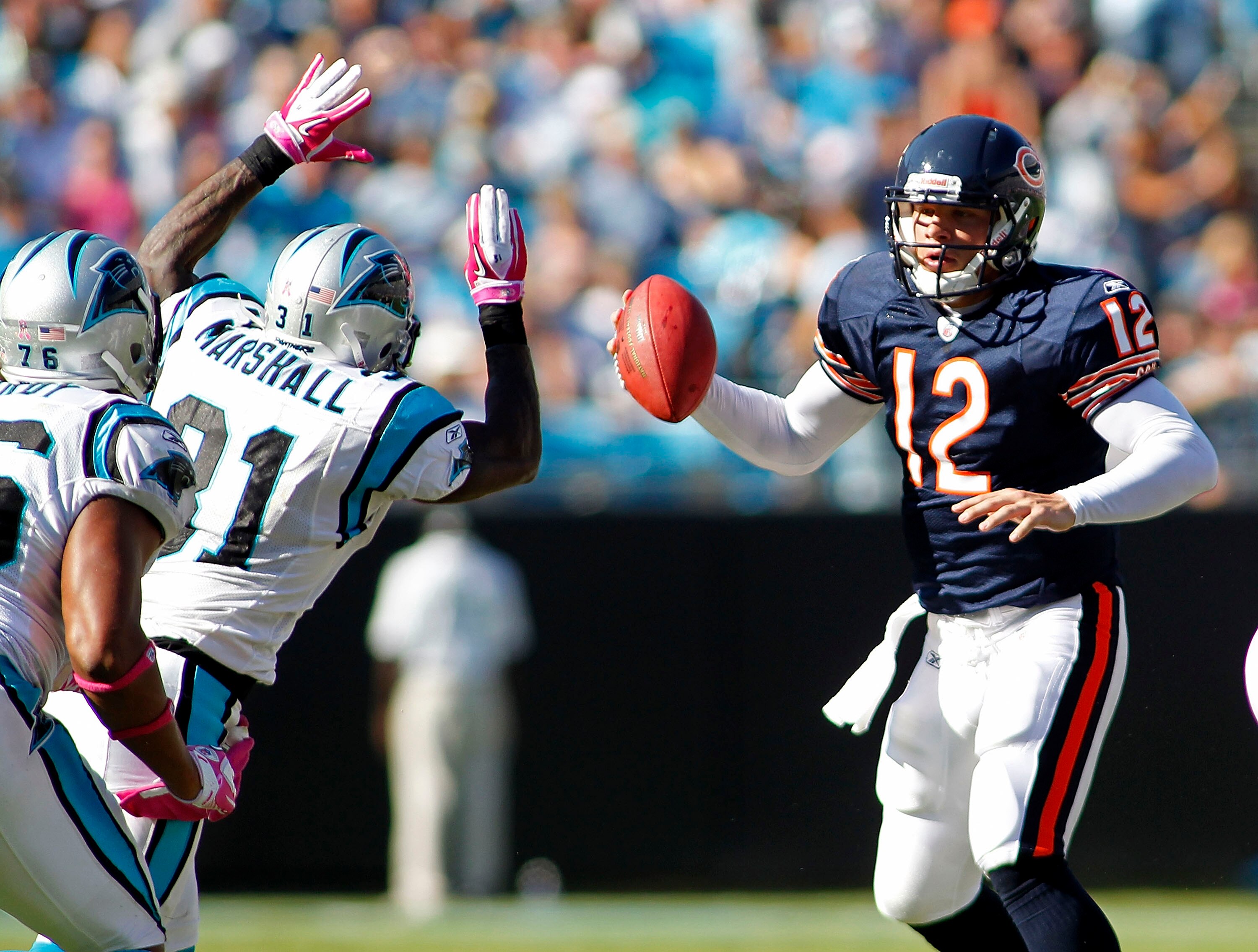 CHARLOTTE, NC - OCTOBER 10: Quarterback Caleb Hanie #12 of the Chicago Bears is sacked by cornerback Richard Marshall #31 of the Carolina Panthers at Bank of America Stadium on October 10, 2010 in Charlotte, North Carolina. (Photo by Geoff Burke/Getty Ima