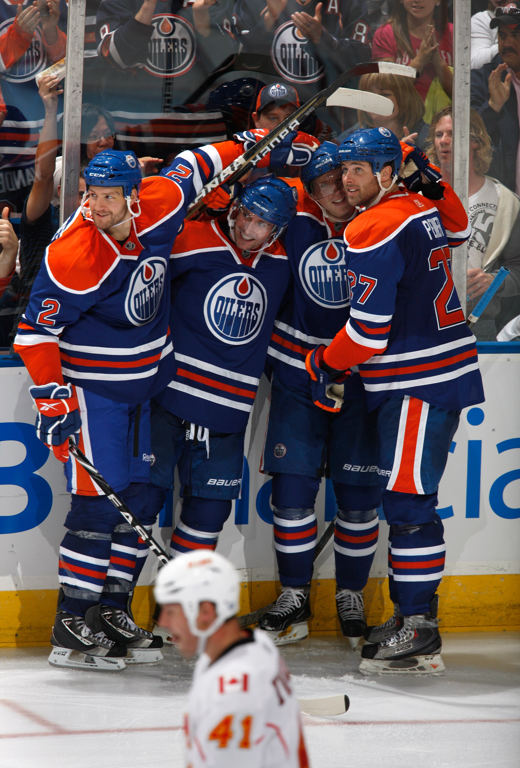 EDMONTON, CANADA - OCTOBER 7:  James Vandermeer #2 and Dustin Penner #27 of the Edmonton Oilers celebrate with teammates against the Calgary Flames at Rexall Place October 7, 2010 in Edmonton, Alberta, Canada. (Photo by Dale MacMillan/Getty Images)