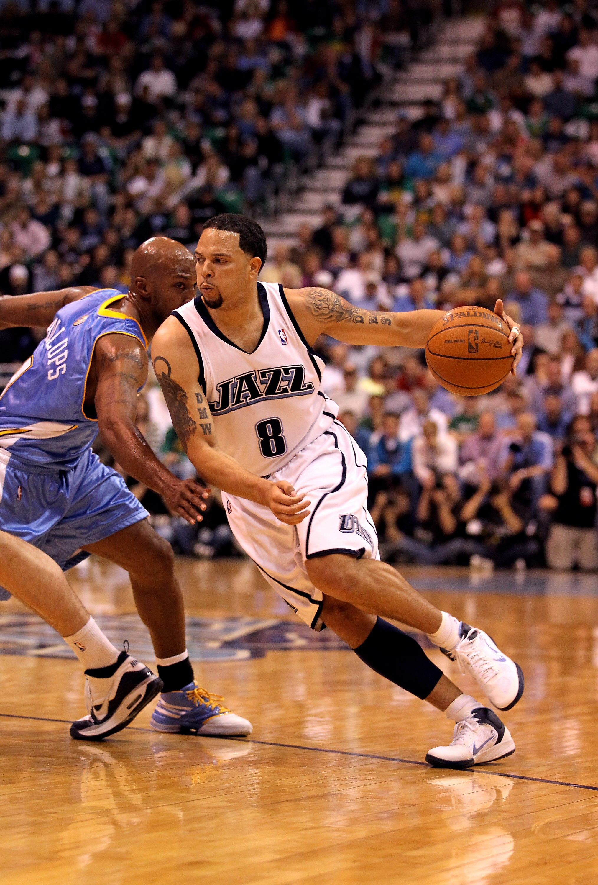 SALT LAKE CITY - APRIL 30:  Deron Williams #8 of the Utah Jazz drives past Chauncey Billups #1 of the Denver Nuggets during Game Six of the Western Conference Quarterfinals of the 2010 NBA Playoffs at EnergySolutions Arena on April 30, 2010 in Salt Lake C