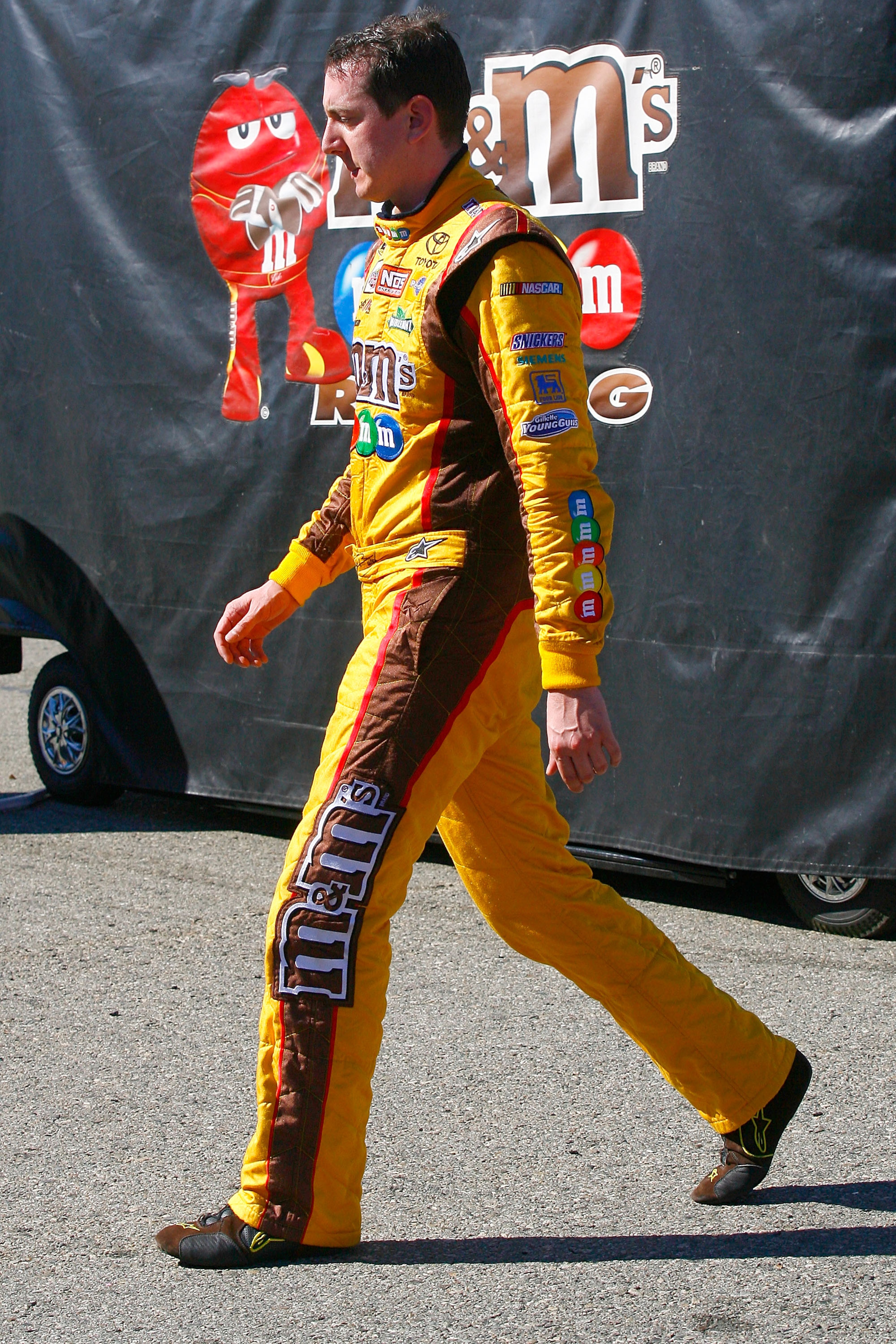 FONTANA, CA - OCTOBER 10: Kyle Busch, driver of the #18 M&M'sToyota, walks in the garage area after blowing a motor during the NASCAR Sprint Cup Series Pepsi Max 400 on October 10, 2010 in Fontana, California. (Photo by Jason Smith/Getty Images for NASC FONTANA, CA - OCTOBER 10: Kyle Busch, driver of the #18 M&M'sToyota, walks in the garage area after blowing a motor during the NASCAR Sprint Cup Series Pepsi Max 400 on October 10, 2010 in Fontana, California. (Photo by Jason Smith/Getty Images for NASC