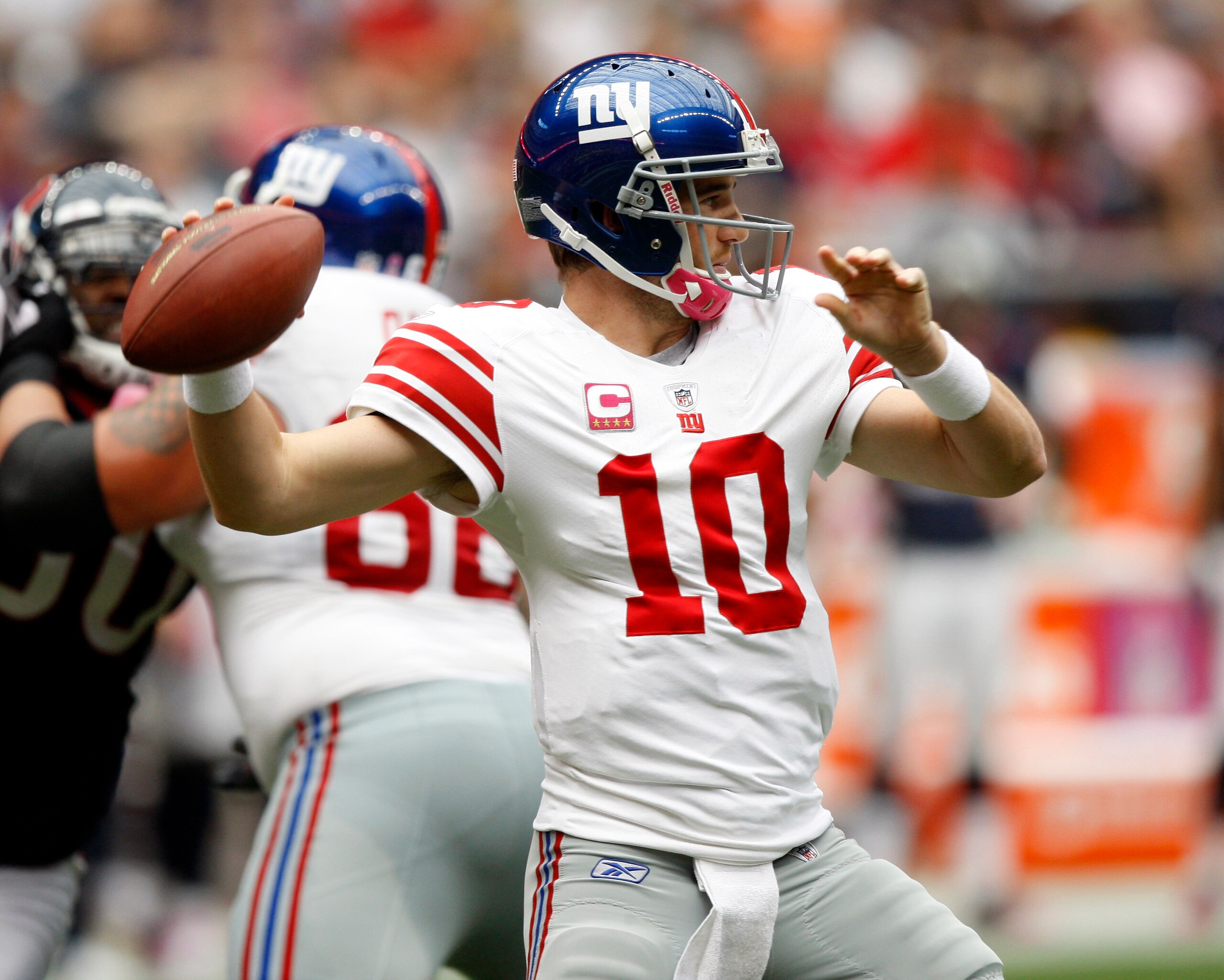 HOUSTON - OCTOBER 10: Quarterback Eli Manning #10 of the New York Giants throws downfield against the Houston Texans at Reliant Stadium on October 10, 2010 in Houston, Texas.  (Photo by Bob Levey/Getty Images)