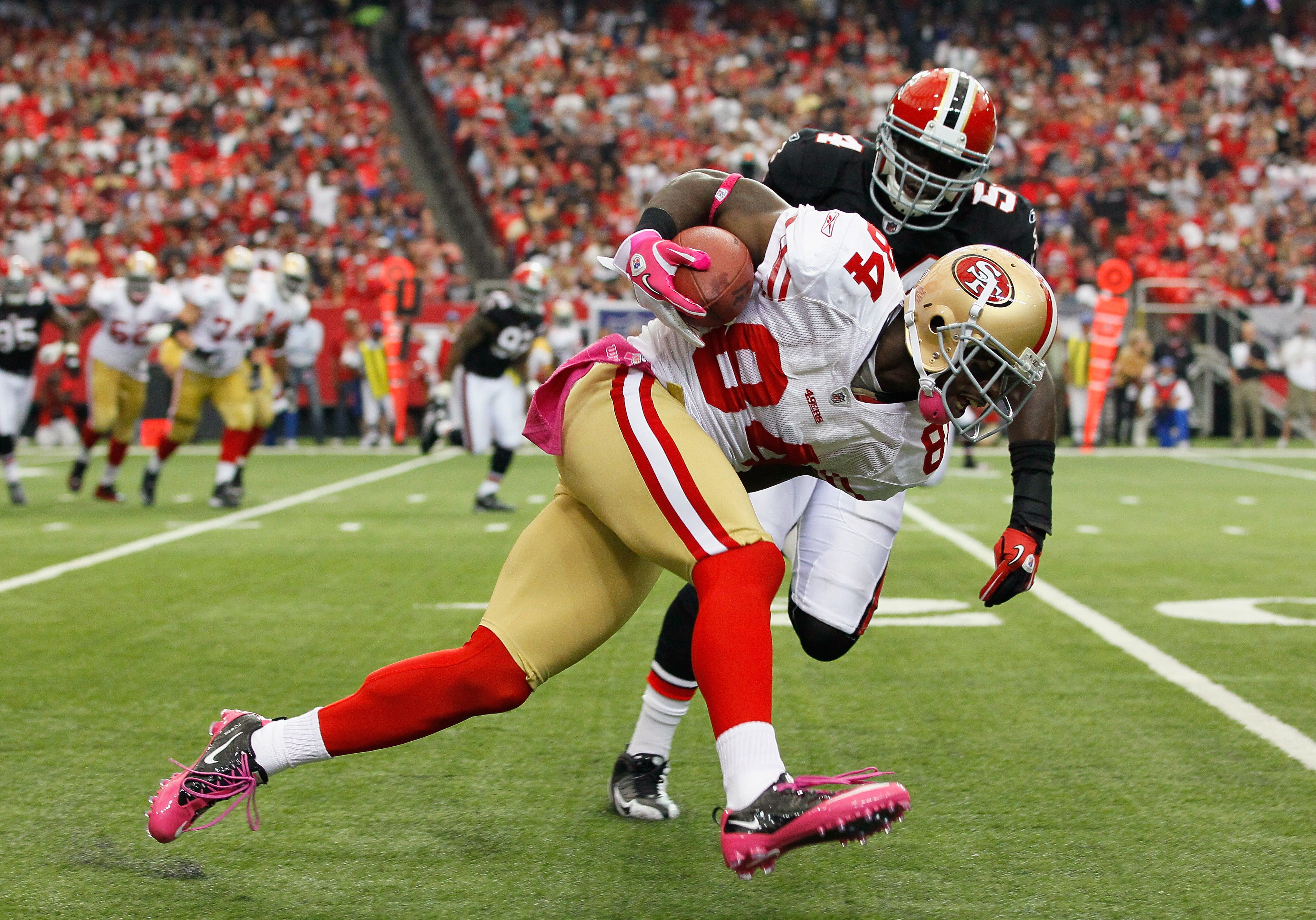ATLANTA - OCTOBER 03:  Josh Morgan #84 of the San Francisco 49ers rushes up the field against Stephen Nicholas #54 of the Atlanta Falcons at Georgia Dome on October 3, 2010 in Atlanta, Georgia.  (Photo by Kevin C. Cox/Getty Images)