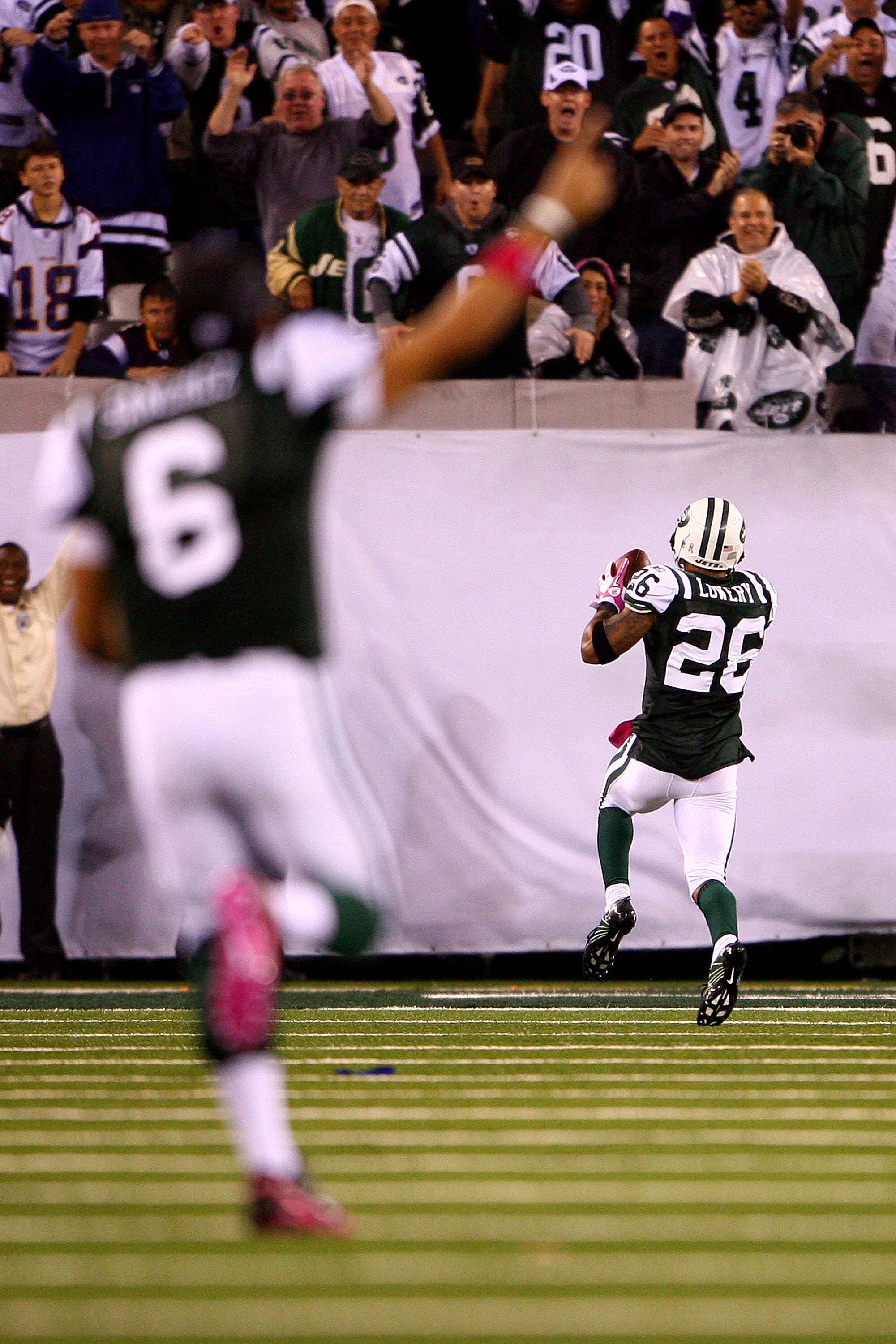 EAST RUTHERFORD, NJ - OCTOBER 11:  Quarterback Mark Sanchez of the New York Jets celebrates as Dwight Lowery #26 scores a 26-yard interception return for a touchdown in the fourth quarter against the Minnesota Vikings at New Meadowlands Stadium on October