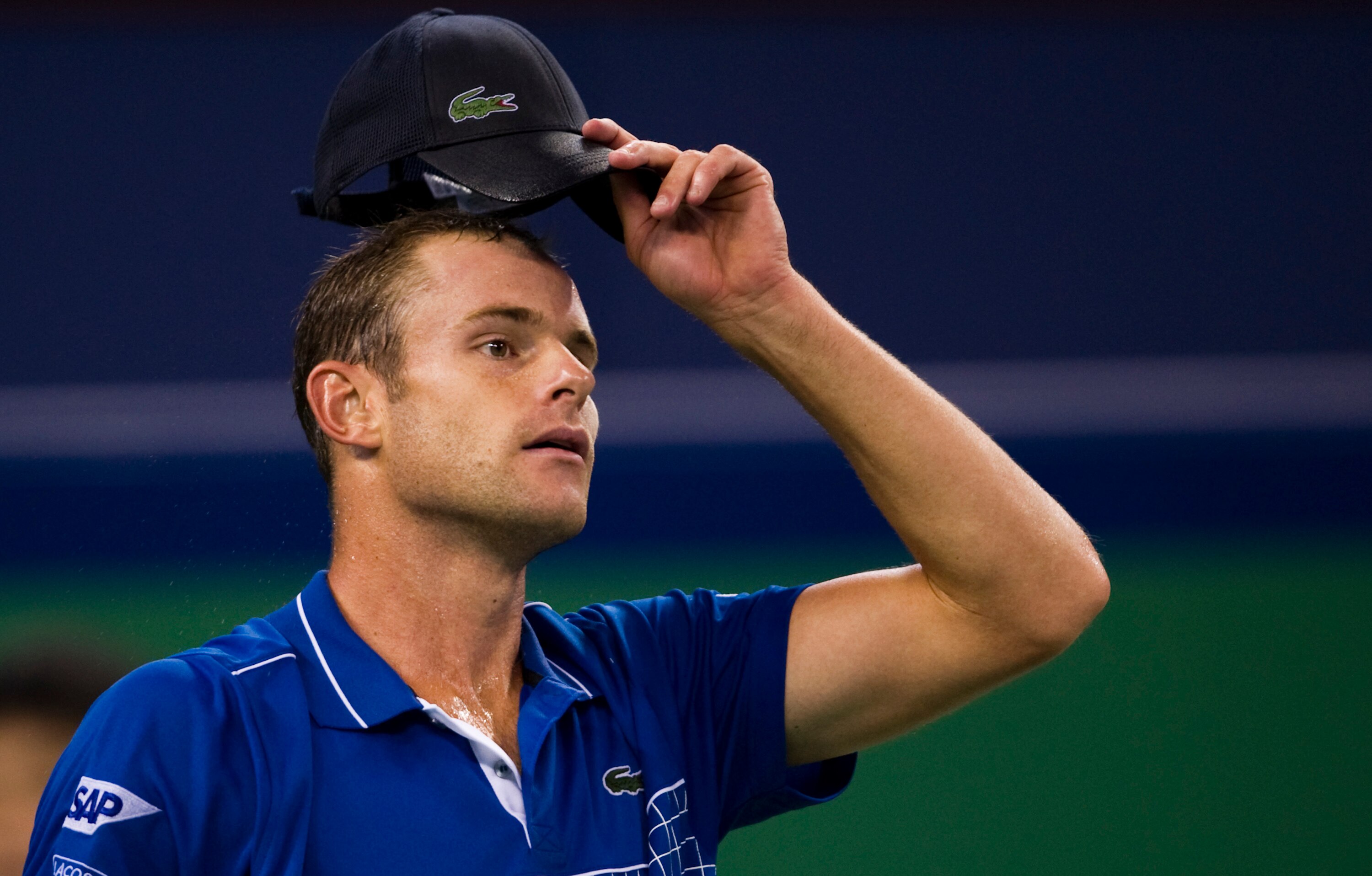 SHANGHAI, CHINA - OCTOBER 12: Andy Roddick of USA adjust his cap on his match against Philipp Kohlschreiber of Germany during day two of the 2010 Shanghai Rolex Masters at the Shanghai Qi Zhong Tennis Center on October 12, 2010 in Shanghai, China.  (Photo
