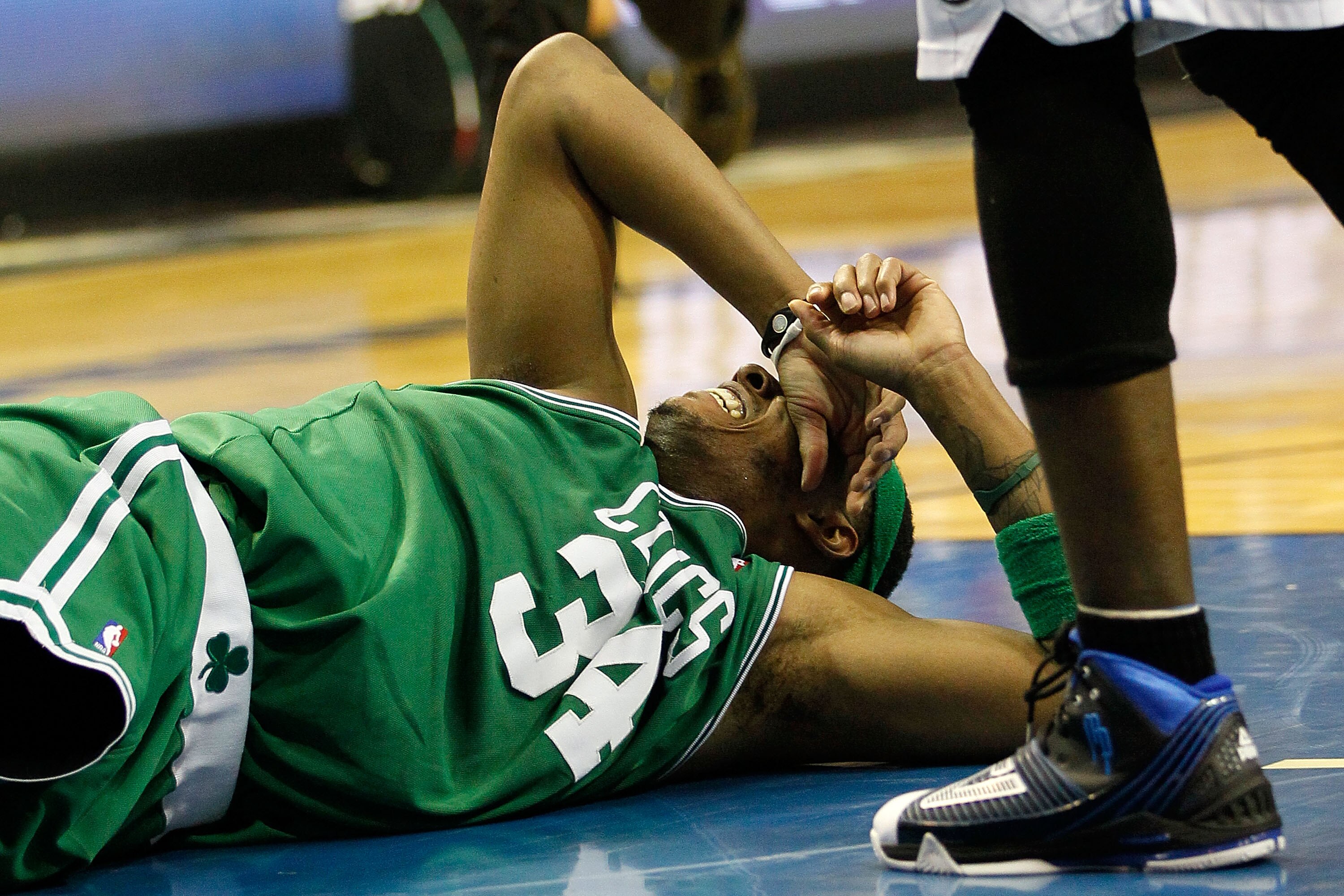 ORLANDO, FL - MAY 18:  Paul Pierce #34 of the Boston Celtics lies on the court in pain after he drew contact from Dwight Howard #12 of the Orlando Magic in the second quarter of Game Two of the Eastern Conference Finals during the 2010 NBA Playoffs at Amw